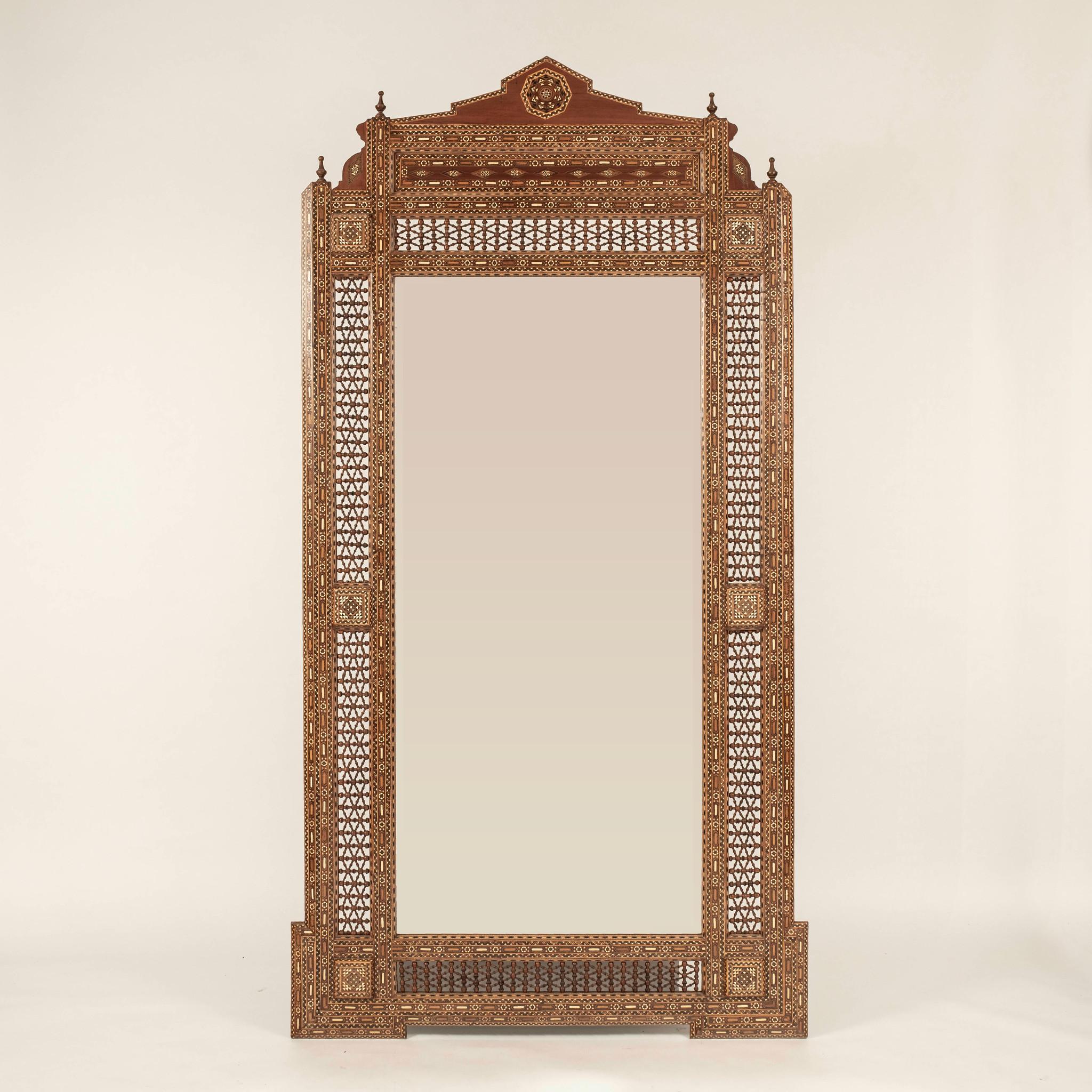 A large scale Damascus mirror. Mixed woods to include walnut feature stunning bone intarsia and hand turned fretwork in an all over geometric pattern.