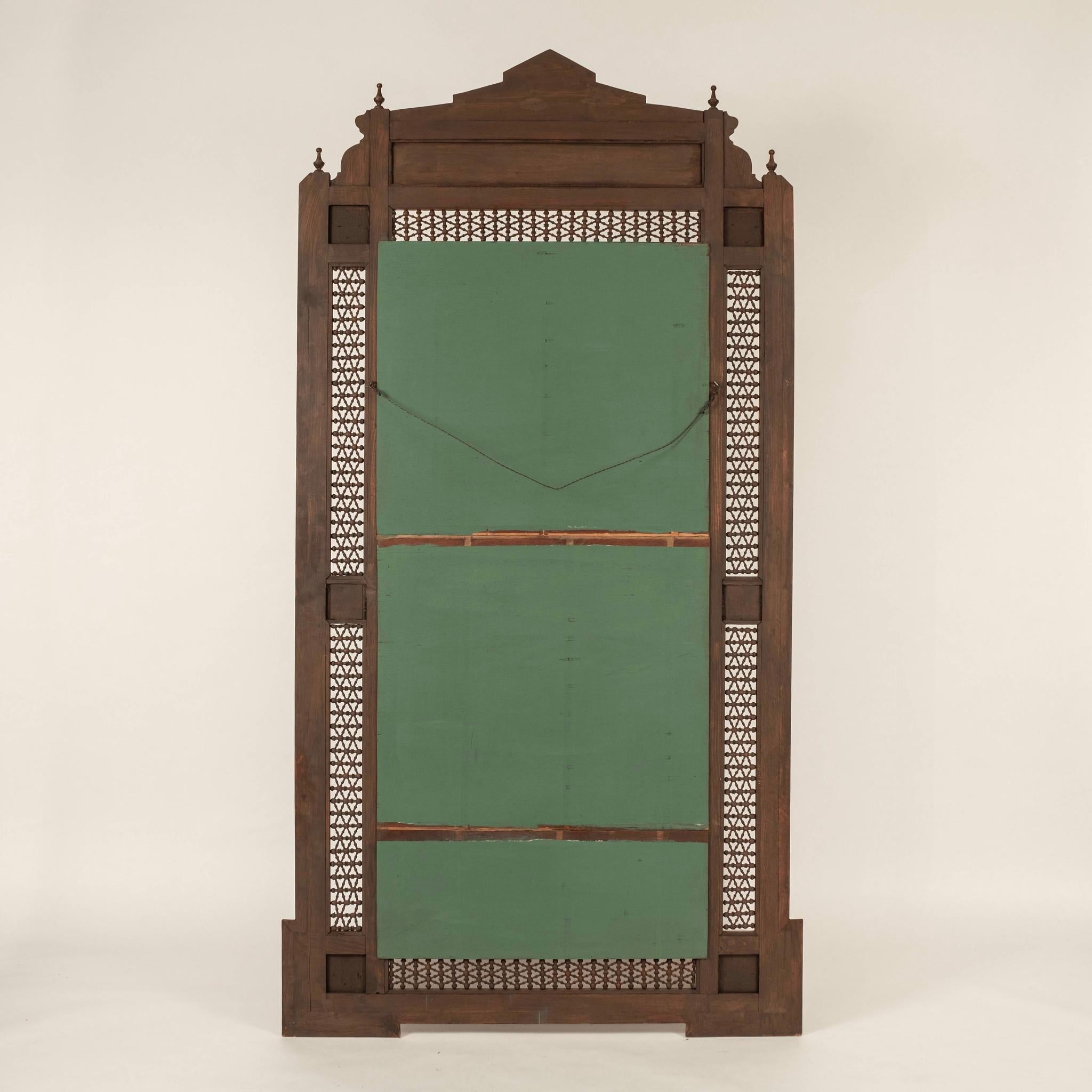 A large scale Damascus mirror: mixed woods to include walnut featuring stunning bone intarsia and hand turned fretwork, in an all over geometric pattern.