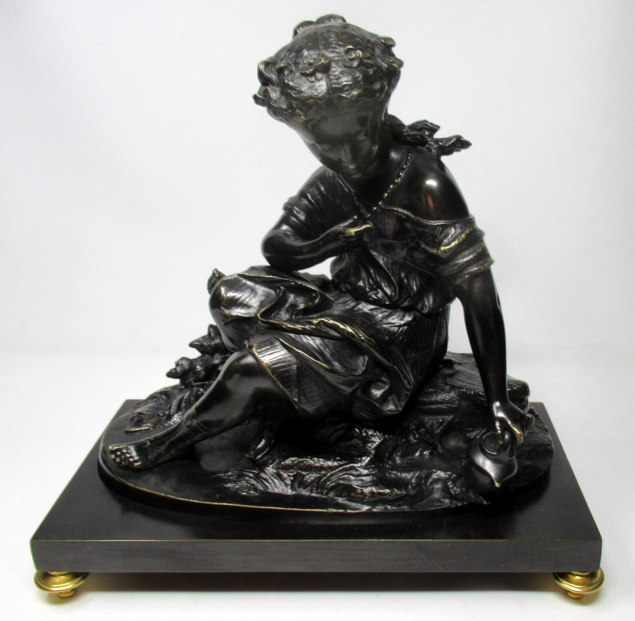 An attractive Grand Tour patinated cast bronze figure of an infant Bacchus seated on a naturalistic base, holding a wine vessel on her left hand, of outstanding quality and medium proportions, possibly after Egisto Rossi 1856-1916, third quarter of