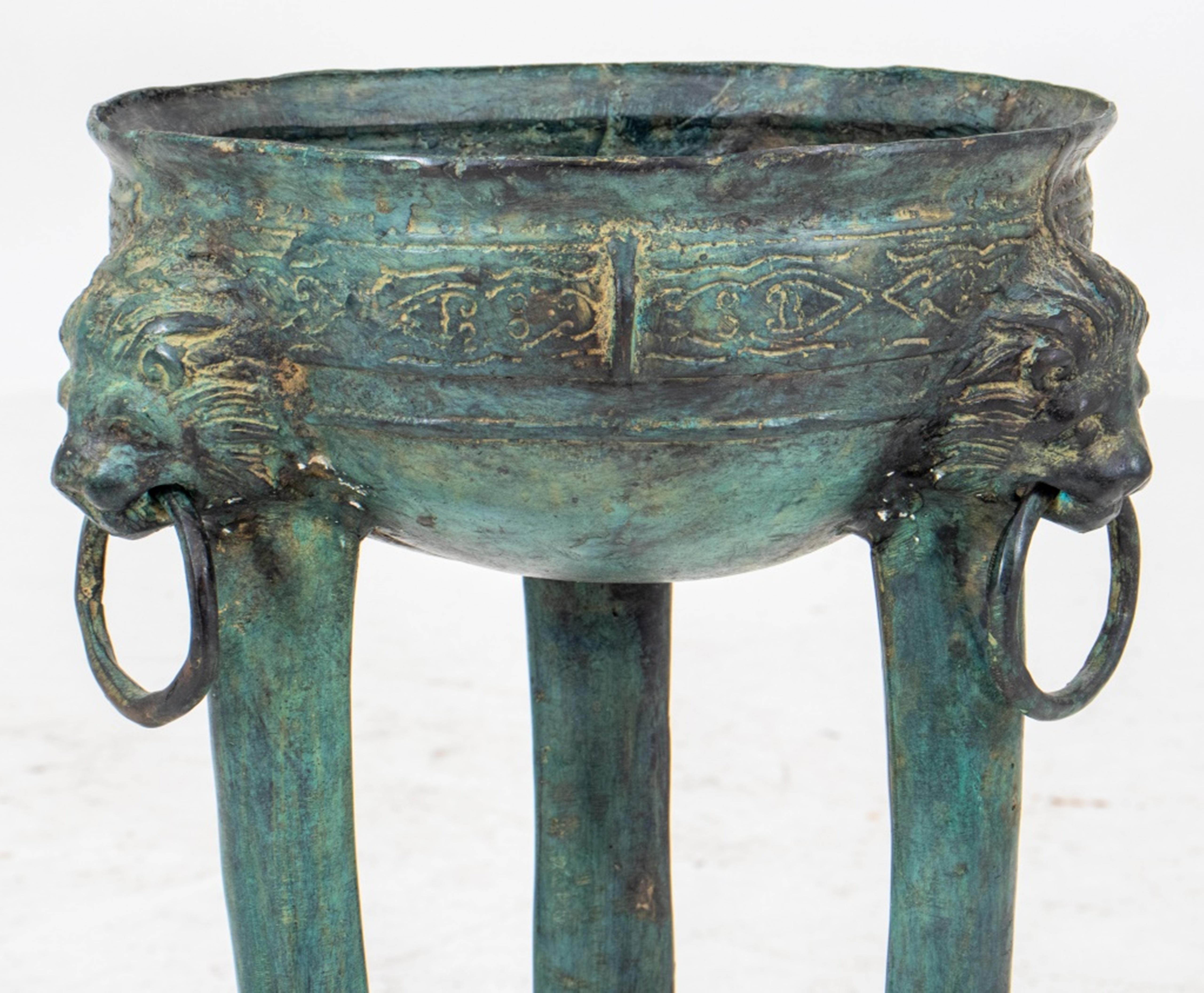 Archeological style verdigris bronze stand, in the manner of Pompeiian work, and in the form of an incense brazier, the round vessel supported by three lion headed lion legs.
Dimensions: 23