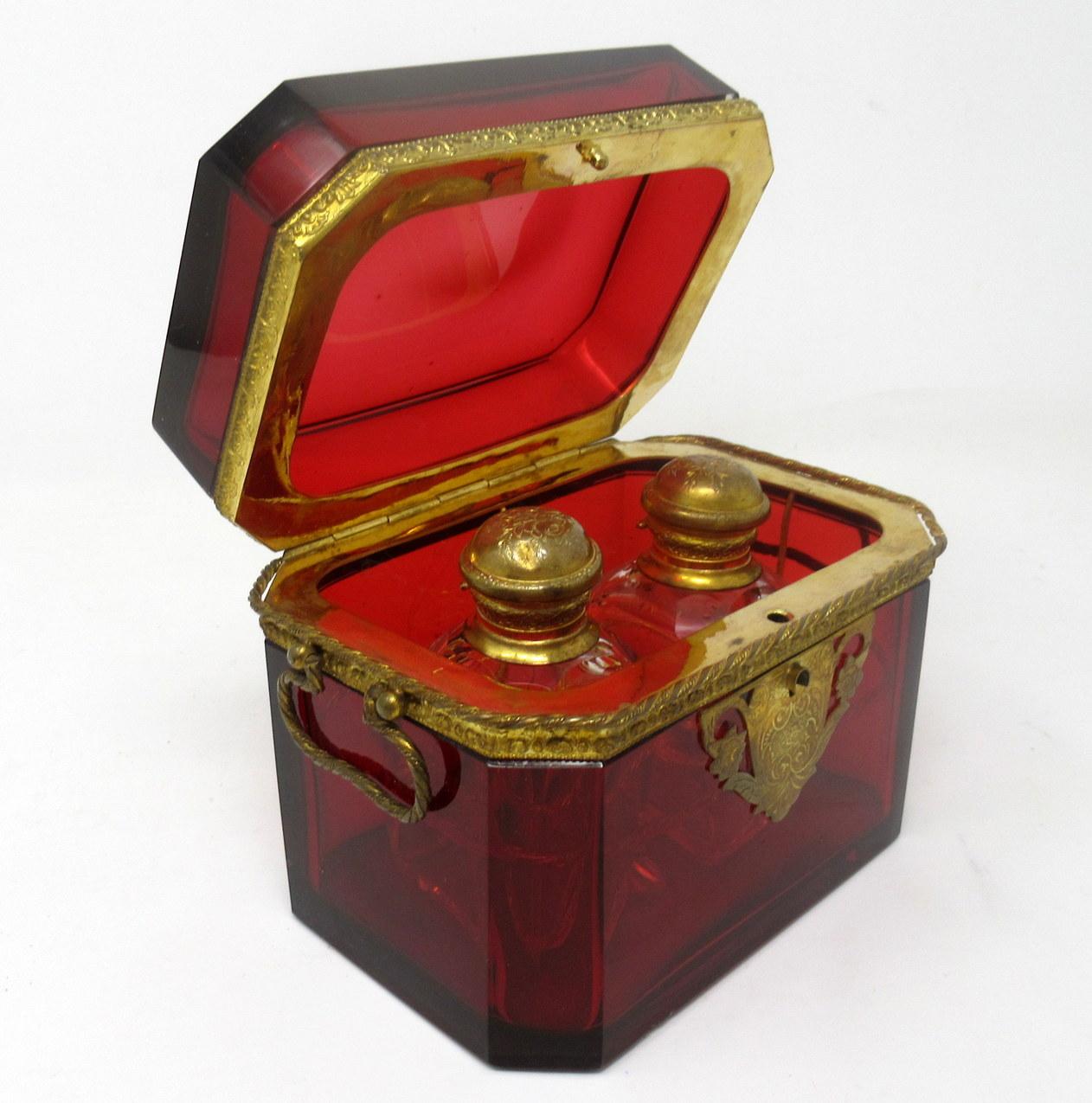 An exceptionally fine quality & quite rare bohemian ruby red crystal glass scent bottle casket made during the last half of the nineteenth century.

The rectangular form heavy gauge hinged lid casket with lavish ormolu mounts and twin carry