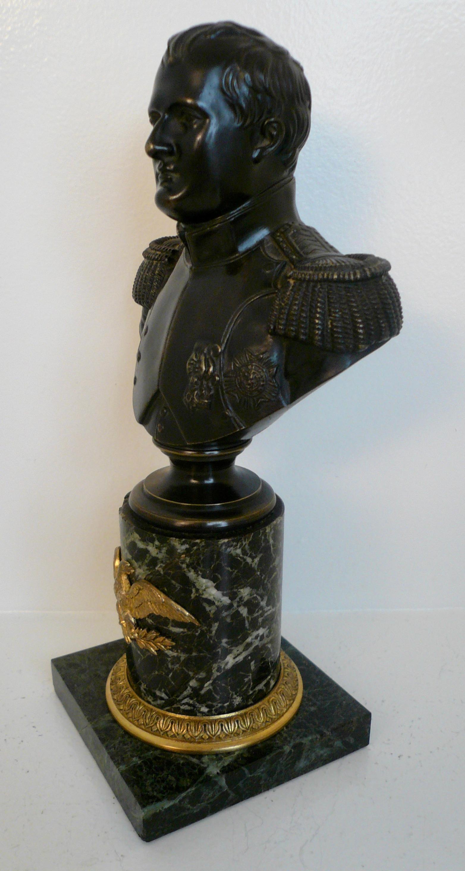 This finely detailed bronze bust of Napoleon features gilt bronze mounts on a verde antique marble base.