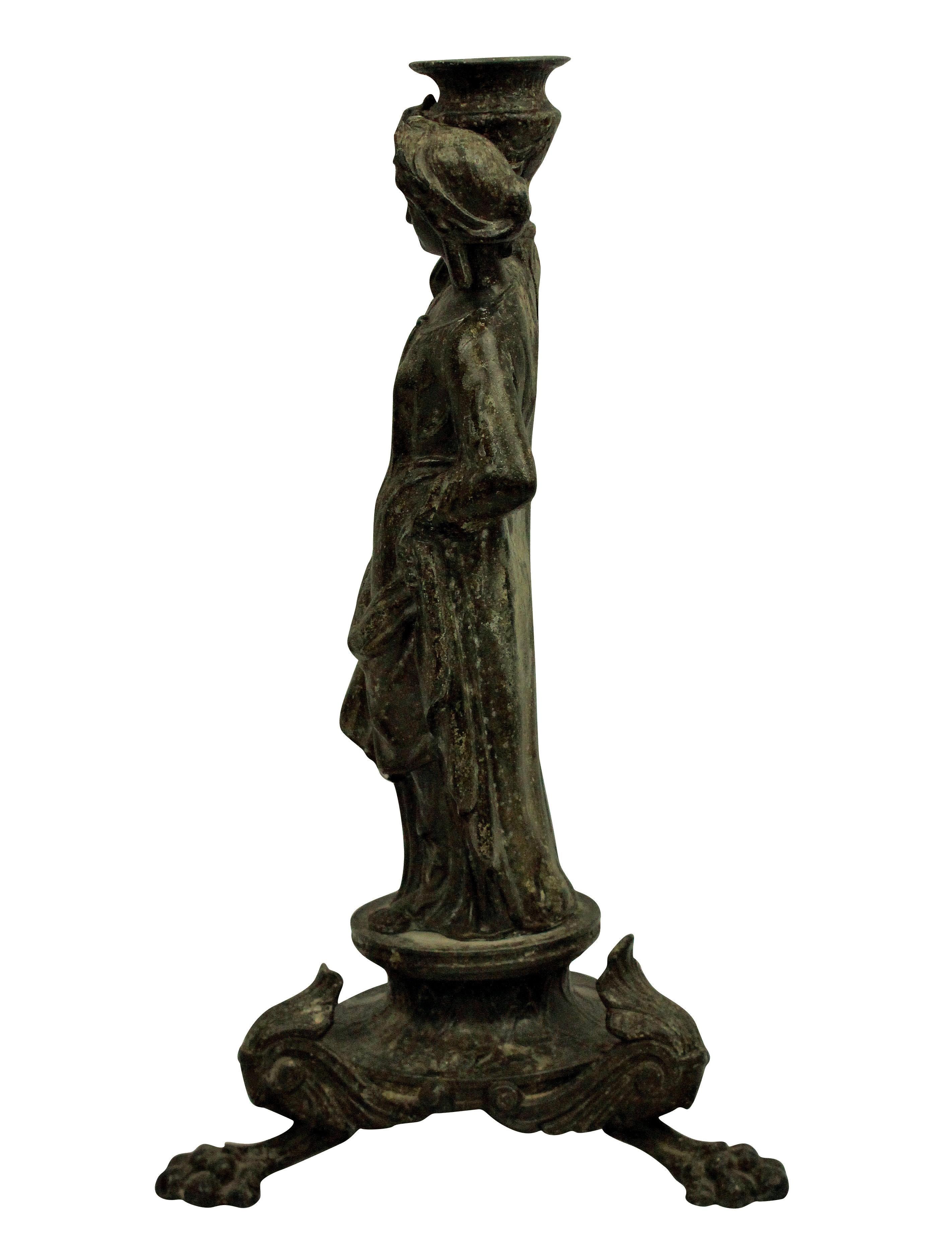 An English Grand Tour bronze candlestick depicting an ancient Greek Danaid.