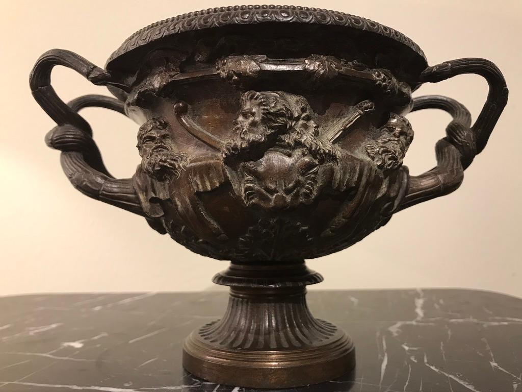 A bronze Grand Tour model of the Warwick vase. The Warwick vase is an ancient Roman marble vase with Bacchic ornament that was discovered at Hadrian's Villa, Tivoli circa 1771 by Gavin Hamilton, a Scottish painter-antiquarian and art dealer in Rome,