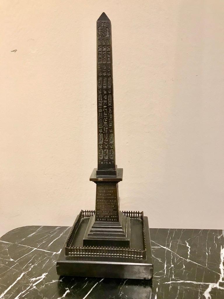 A very fine bronze cast of the Luxor Obelsik, with crisp detailing throughout. Mounted on a polished black slate base. 

The Luxor Obelisk is over 3,000 years old and was originally situated outside of Luxor Temple, where its twin remains to this