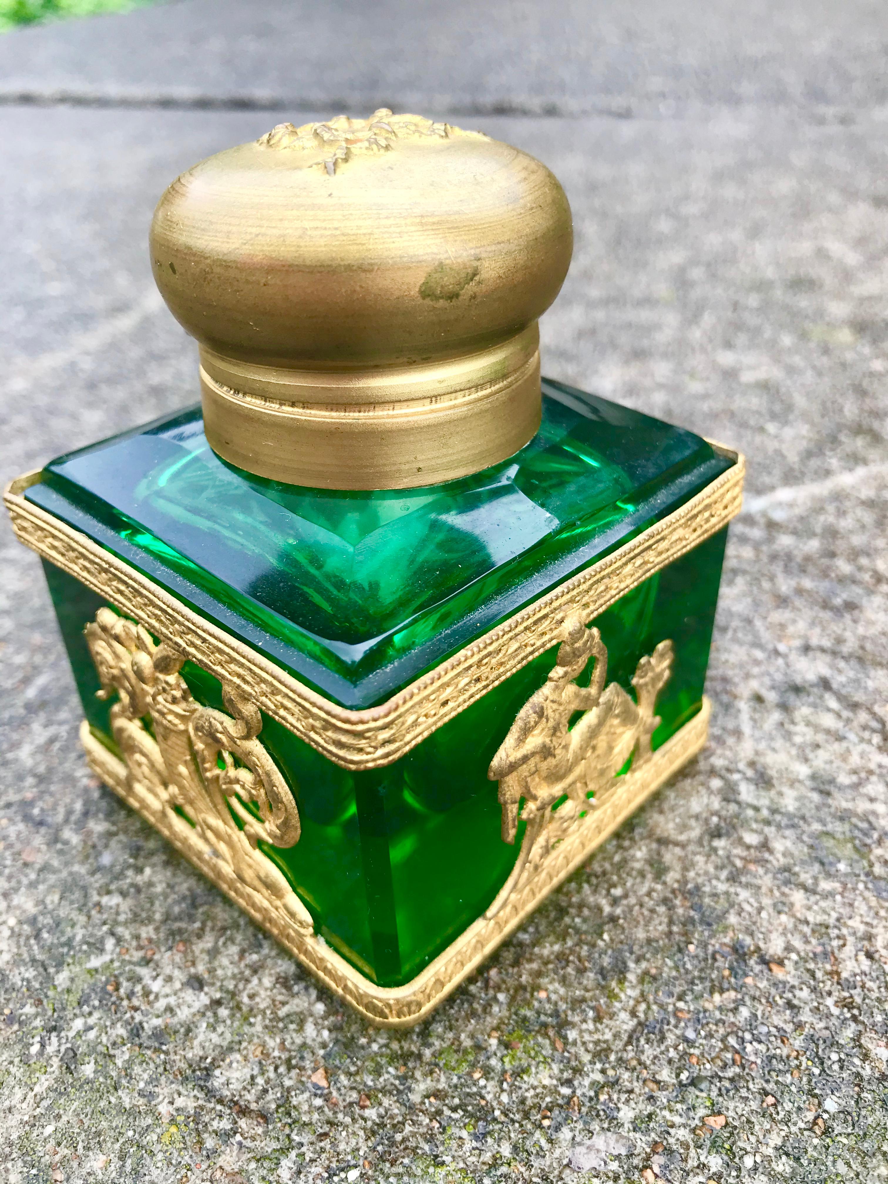 Green glass with gilt mounts of classical design. Lid with laurel. Rubbing to the gilt frieze and figures.

Brilliant color. General wear and typical grime. No chips to glass. Pretty much as seen in photos. Diminutive .
  