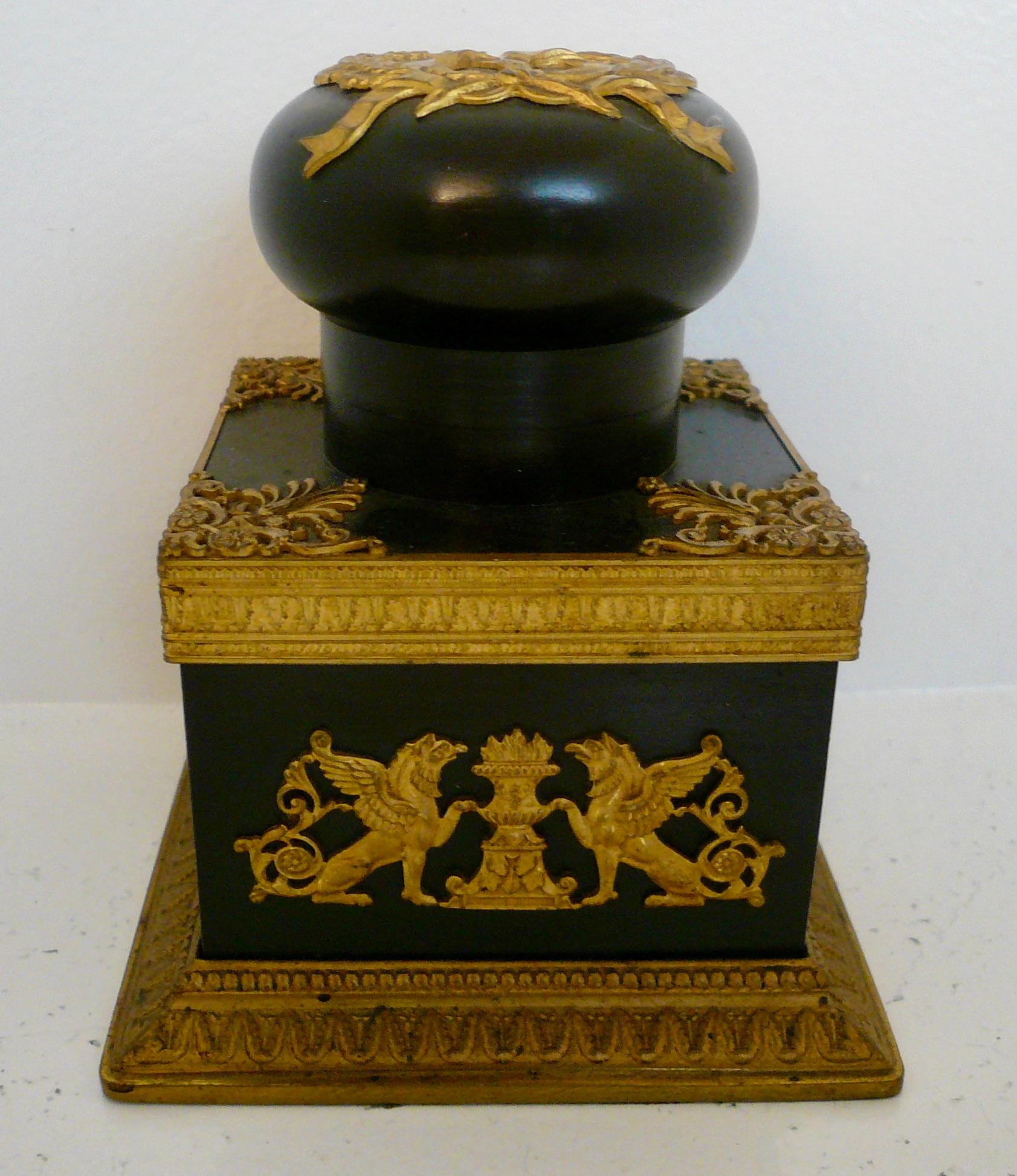 This handsome Napoleonic bronze inkwell features gilt bronze mounts of 
Neo-classical design.