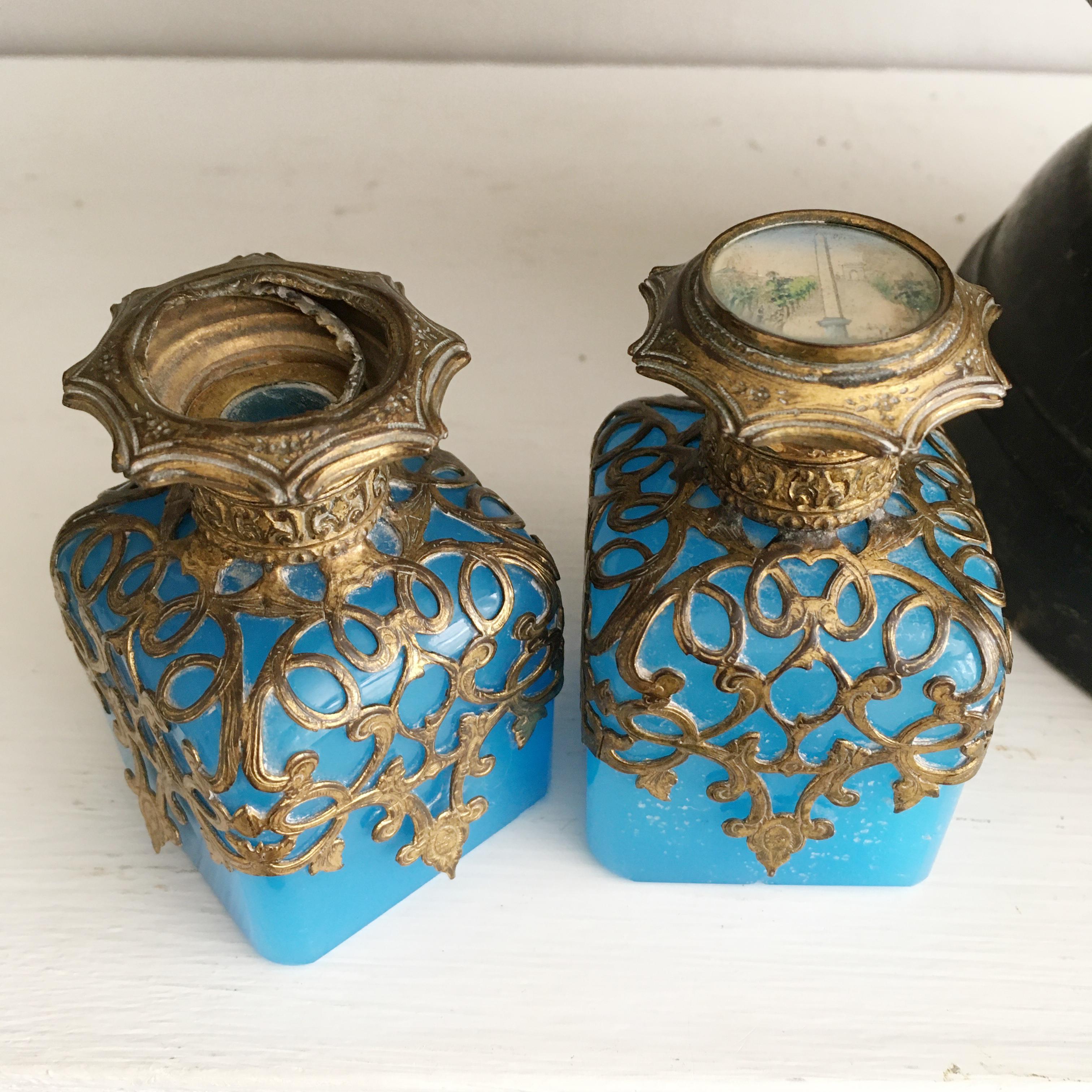 These exquisite 19th century Palais Royal blue opaline and d'ore bronze (Ormolu) perfume bottles from the Grand Tour circa 1860, a beautiful example of French opaline art glass.

The hinged lid on one bottle has a miniature of the Arc De Triomphe