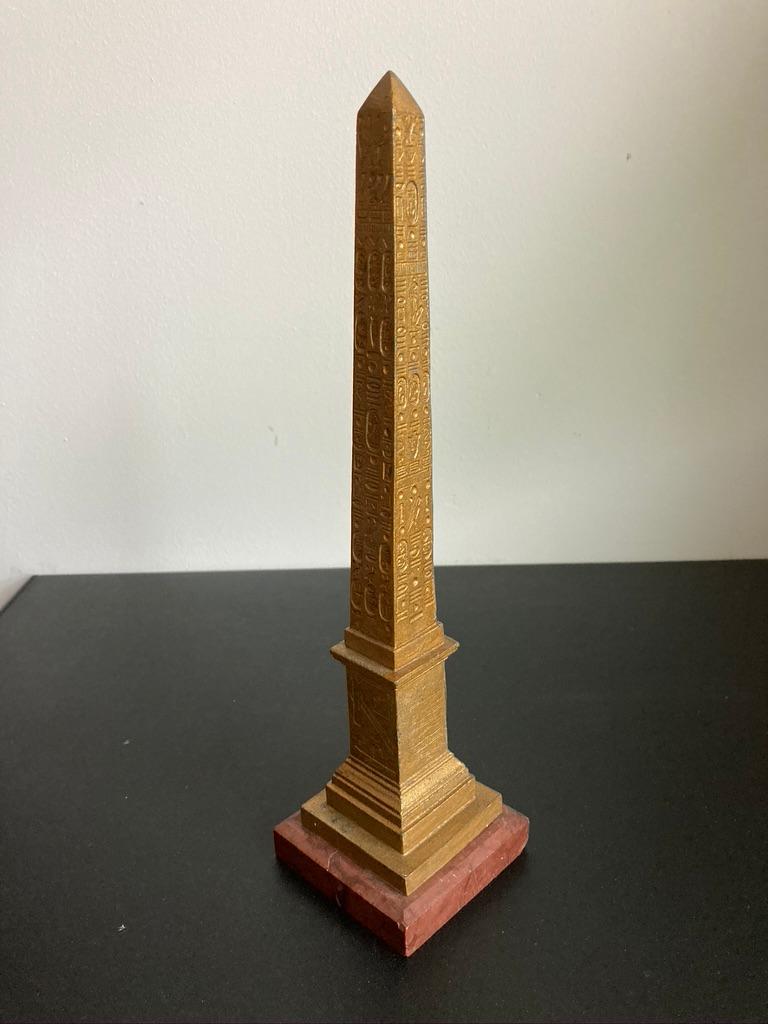 A gilt metal cast of the Luxor Obelsik mounted on a rouge marble base. This was a popular Grand Tour souvenir in the late 19th century, France, 19th century.

The Luxor Obelisk is over 3,000 years old and was originally situated outside of Luxor
