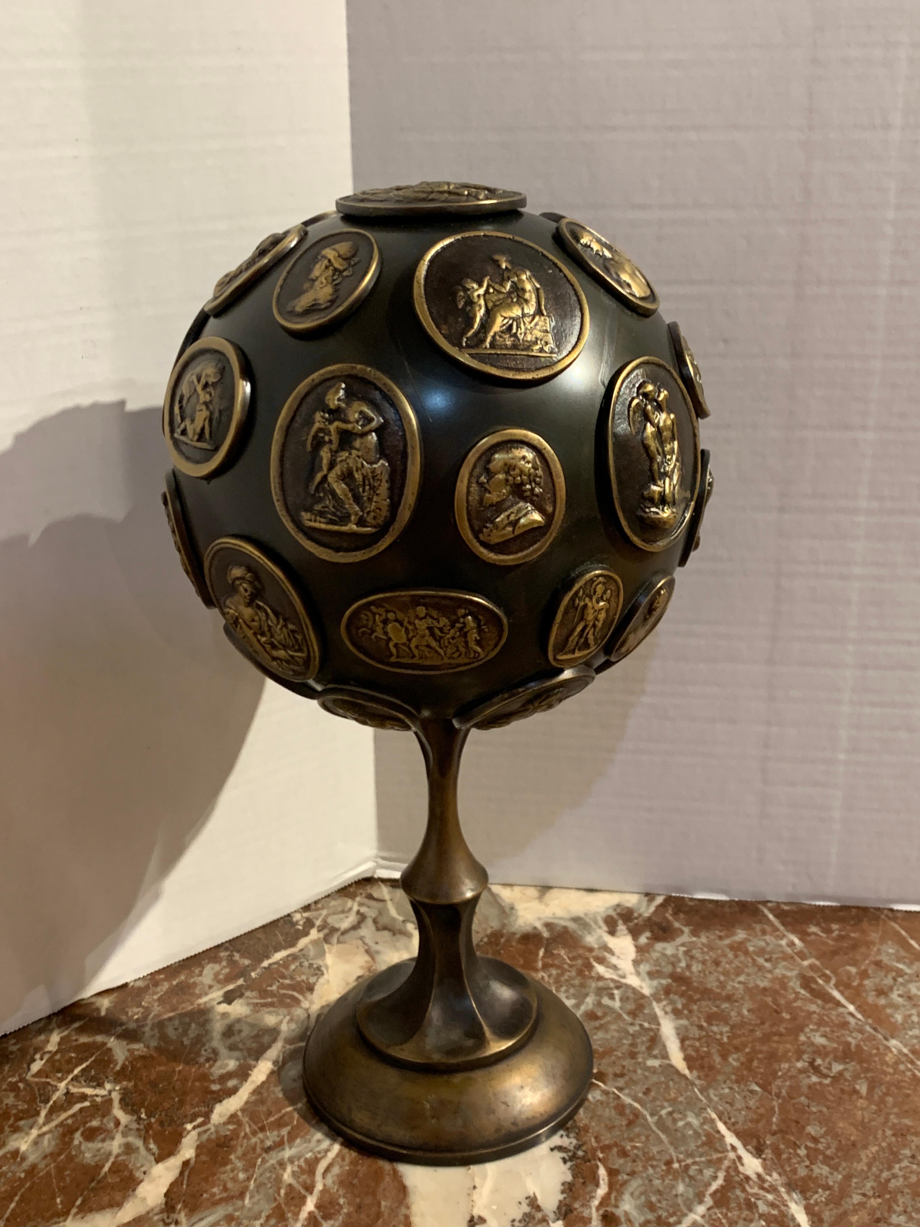 Grand Tour gilt and patinated bronze orb with intaglios, A rare and unusual form, with numerous (over 30) bronze intaglios of great works of art on an 8-Inch diameter orb/sphere, raised on a 5-Inch circular pedestal base.
  
