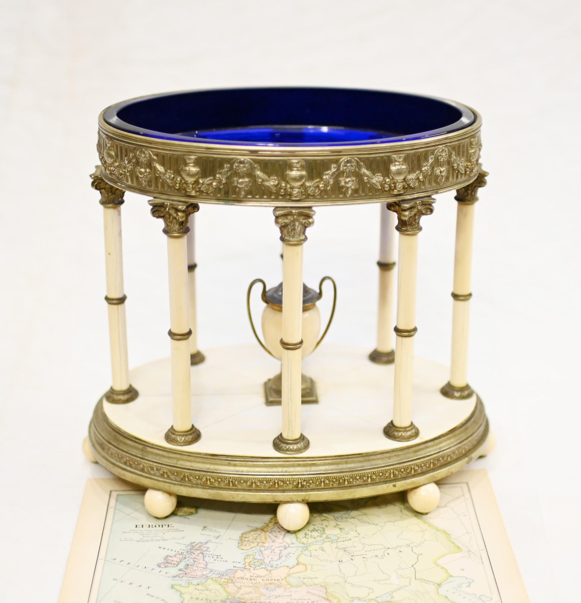 Gorgeous Grand Tour model of an oval temple we date to circa 1890
Such an elegant piece crafted from bone and silver plate
Classic Corinthian columns support the silver plate pediment in which the Bristol colbalt blue glass dish sits
In the centre