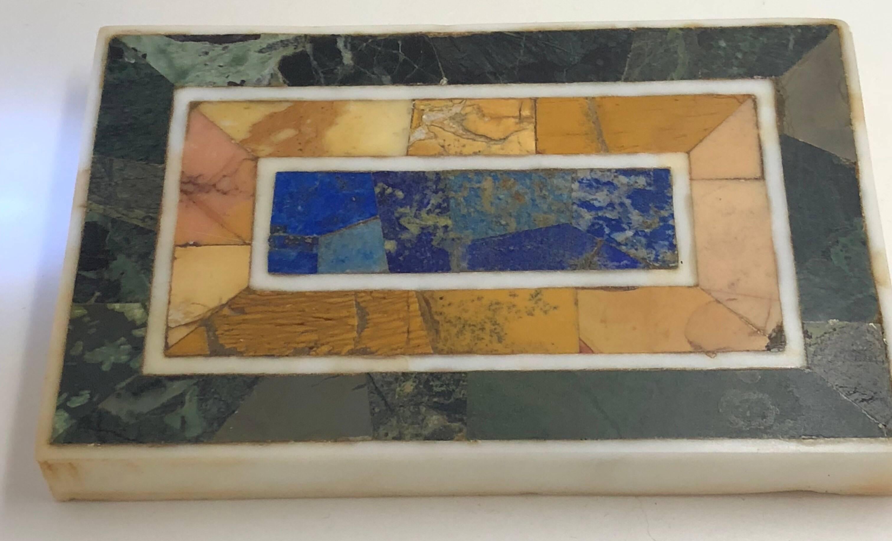 The center made up of blue marble veneers, yellow marble and green marble with each section banded by Carrara marble.