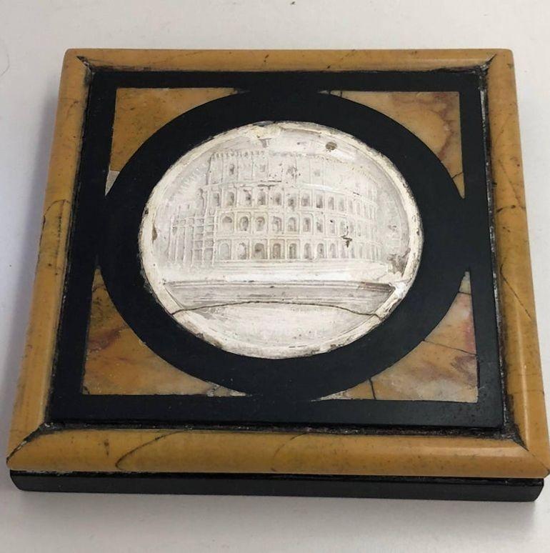 The paperweight inset with a plaster cast of the Coliseum, outlined in 'marmo nero' and marmo giallo.