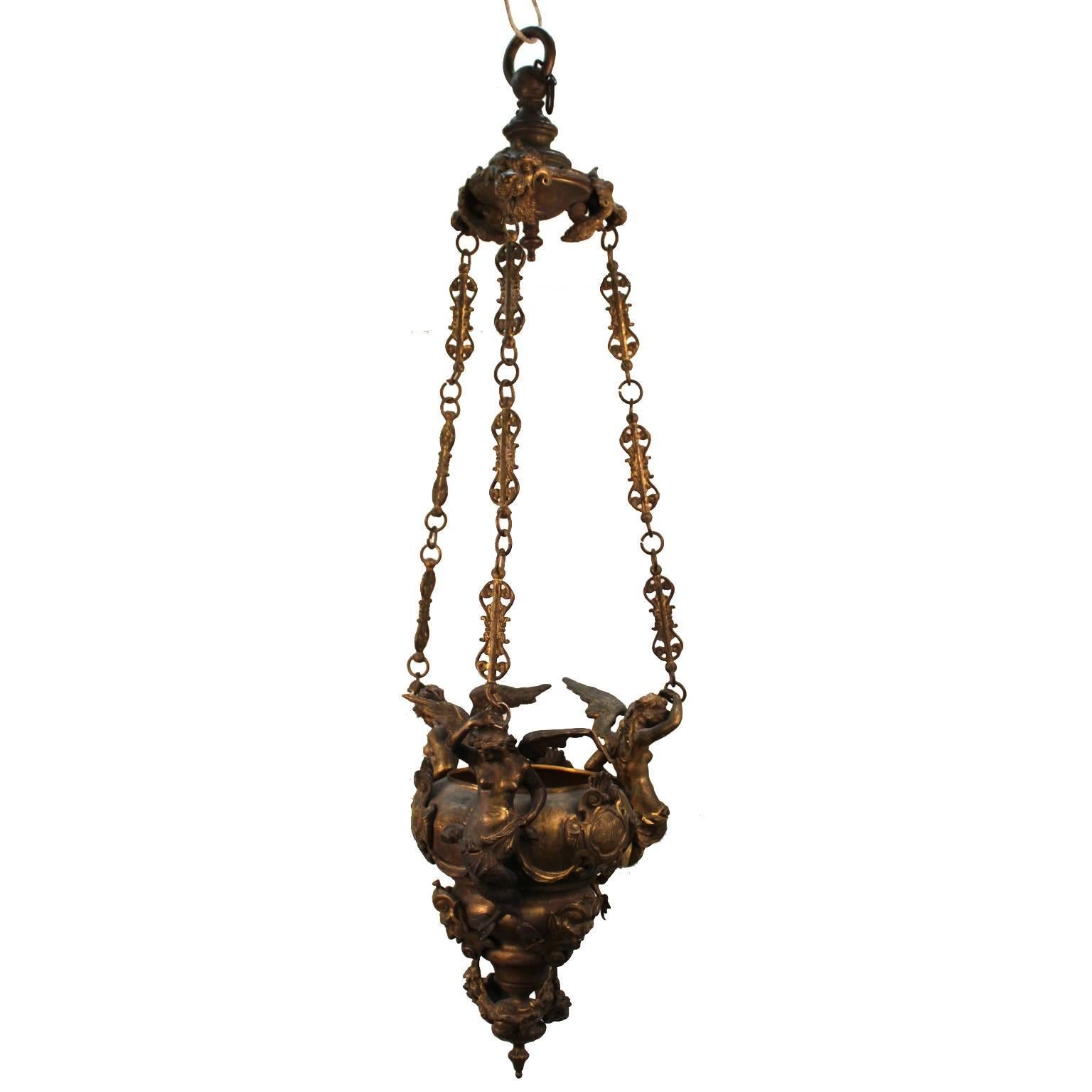 An 1870s Italian Historicist reproduction of a Baroque oil lamp in gilt bronze with winged mermaids and grotesques. Possibly made as a Grand Tour copy of an original lamp from the church of San Sebastiano in Venice. The piece bears the date '1548'