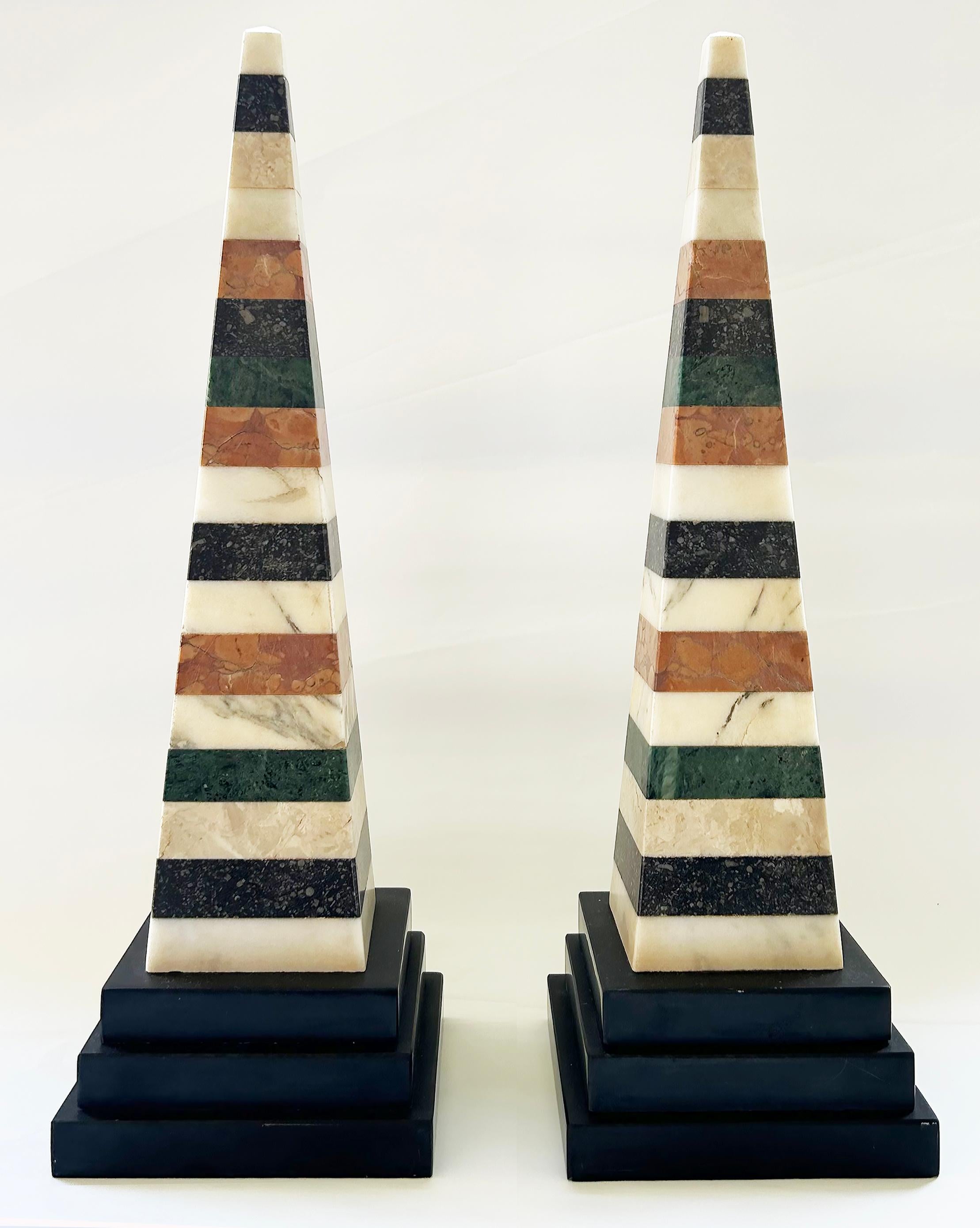 Grand Tour Italian Specimen Marble Pair of Lovely Obelisks

Offered for sale is a wonderful pair of Italian grand tour period obelisks created from stacked marble pieces. The obelisks are striking and elegant and will make lovely additions to a