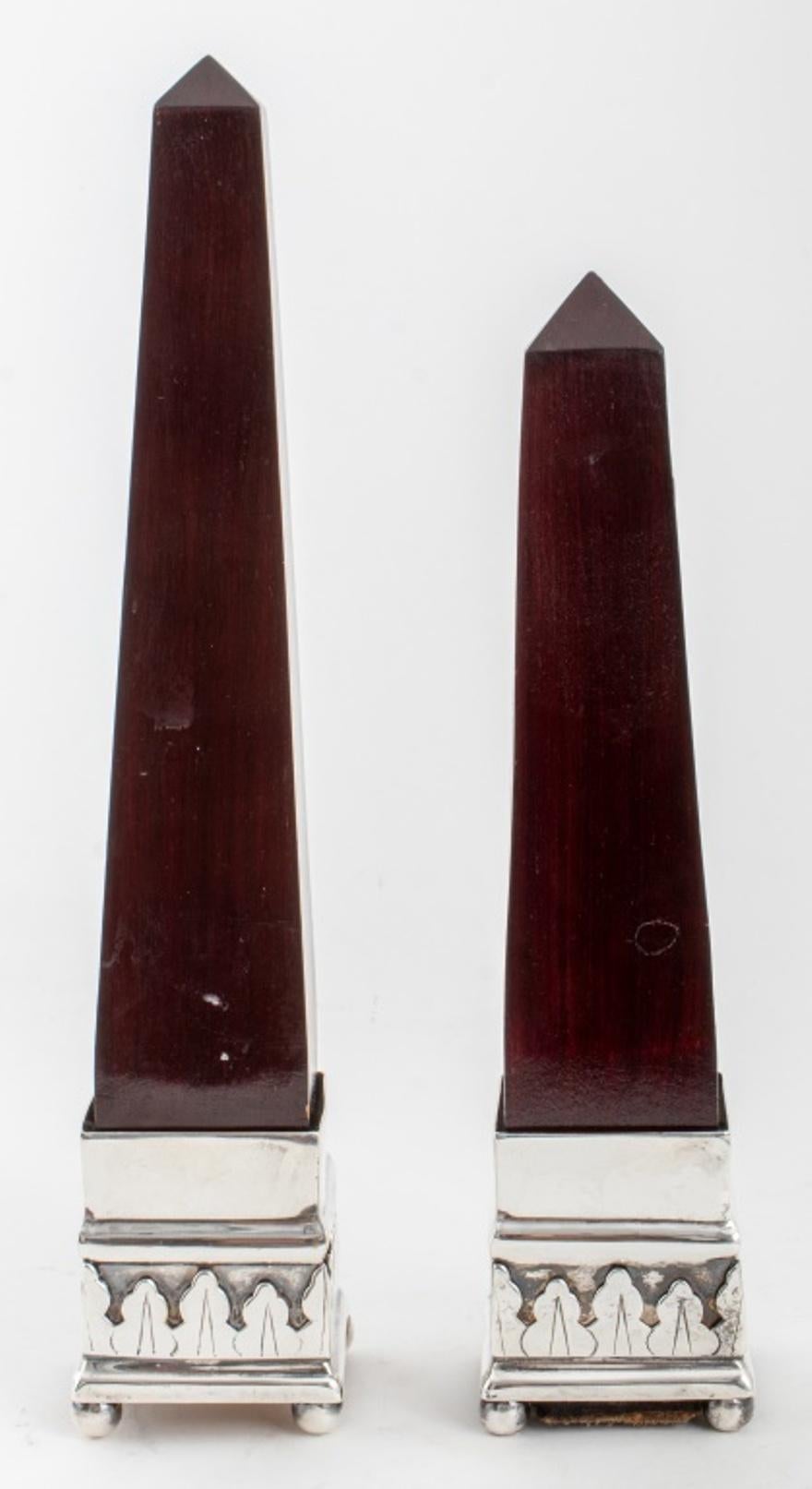 Grand Tour manner pair of mahogany obelisks, raised on a chased silvered metal base. Tallest: 13