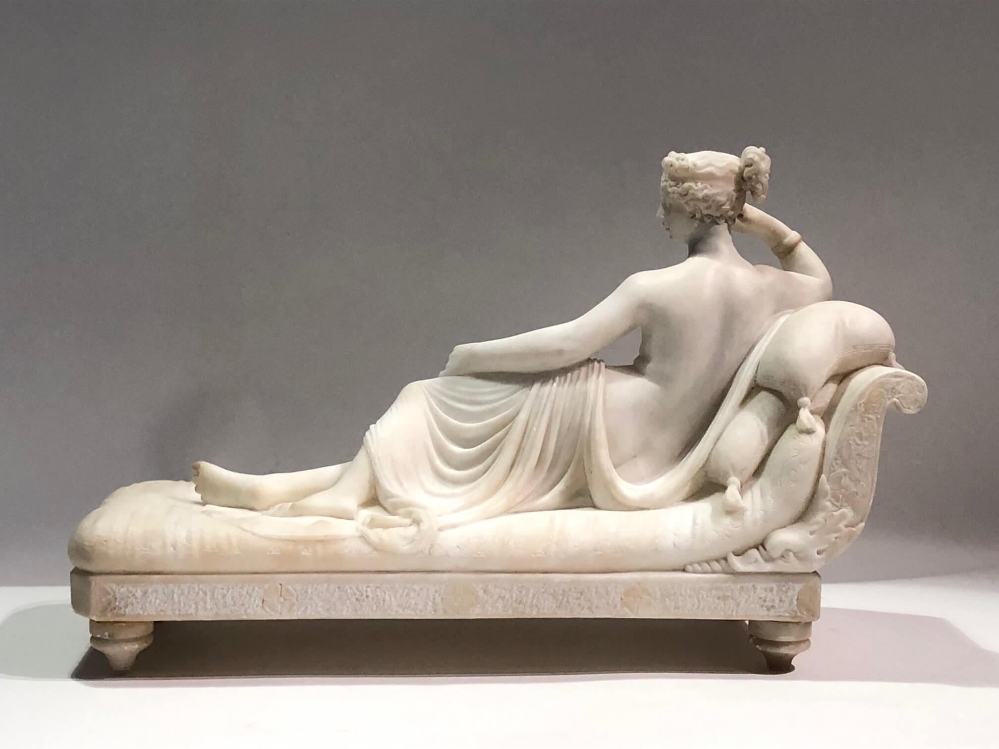 Second-half 19th century Italian Grand Tour model of Pauline Bonaparte Borghese as Venus Victrix in exquisitely carved alabaster; the nude figure reclining on a neoclassical récamier with apple in hand after the original life-sized sculpture carved