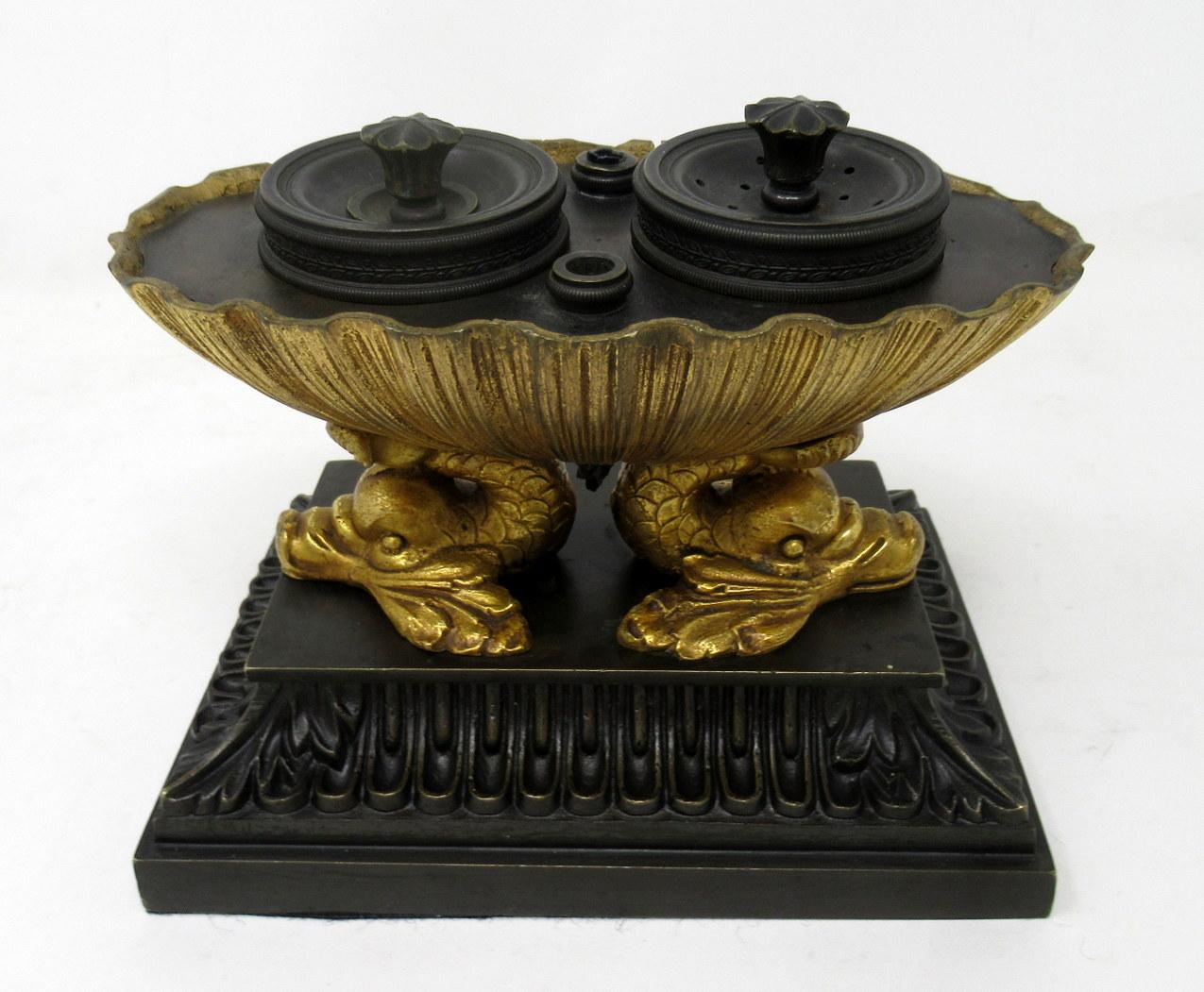 A superb example of an early 19th century Grand Tour English Regency ormolu and patinated bronze inkstand Standish of outstanding quality, in the manner of Thomas Messenger. 

The inverted gilded oval shell enclosing two glass ink bottles fitted