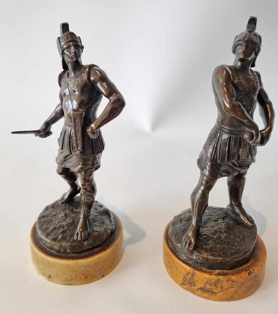 A fine pair of Italian Grand Tour patinated bronze gladiators. One with his dagger drawn, the other about to draw his. Both in plumed helmets. Superb original patination and detail. Set on fine sienna marble bases.