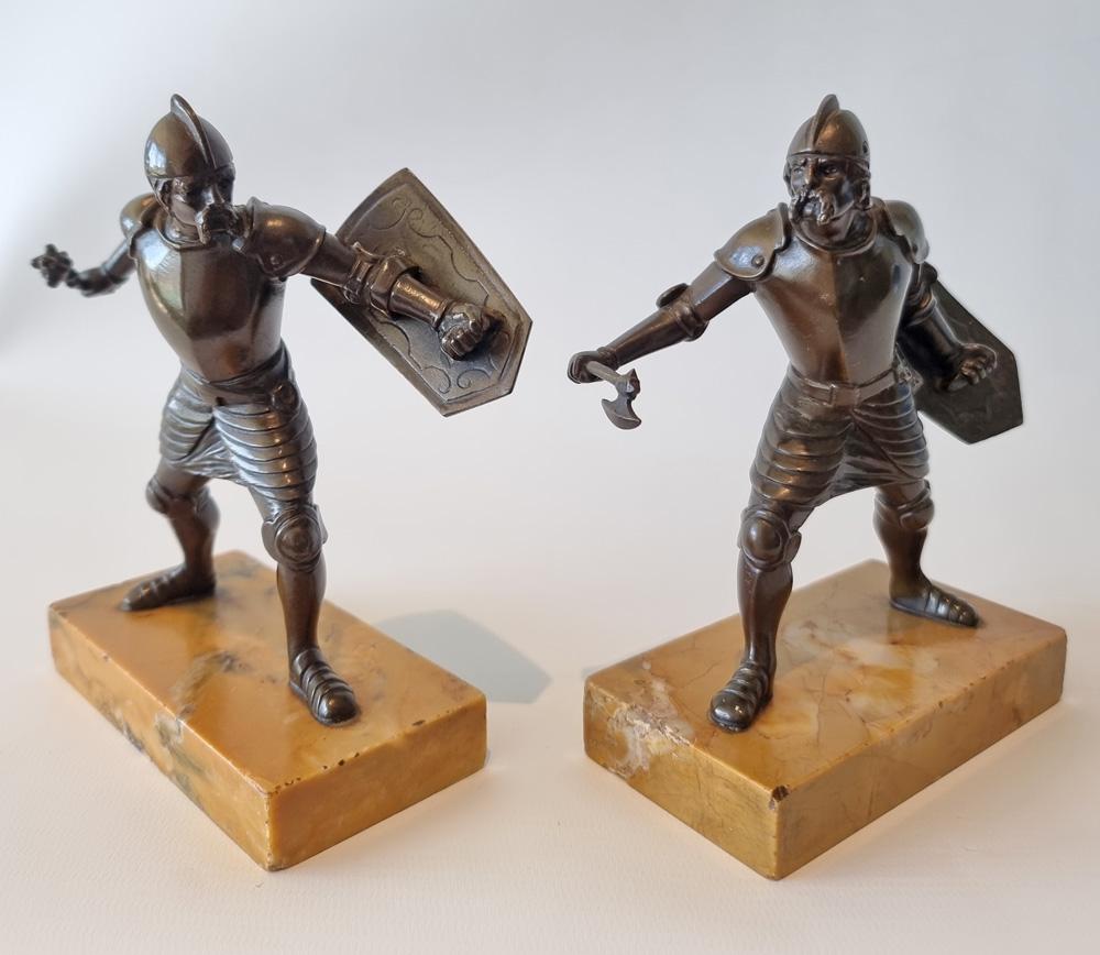 Grand tour bronzes of fighting men set on Sienna marble bases of very good colour. The two warriors in full armour and looking like medieval or renaissance soldiers are in a fighting stance both carrying shields and one carrying a mace and the other