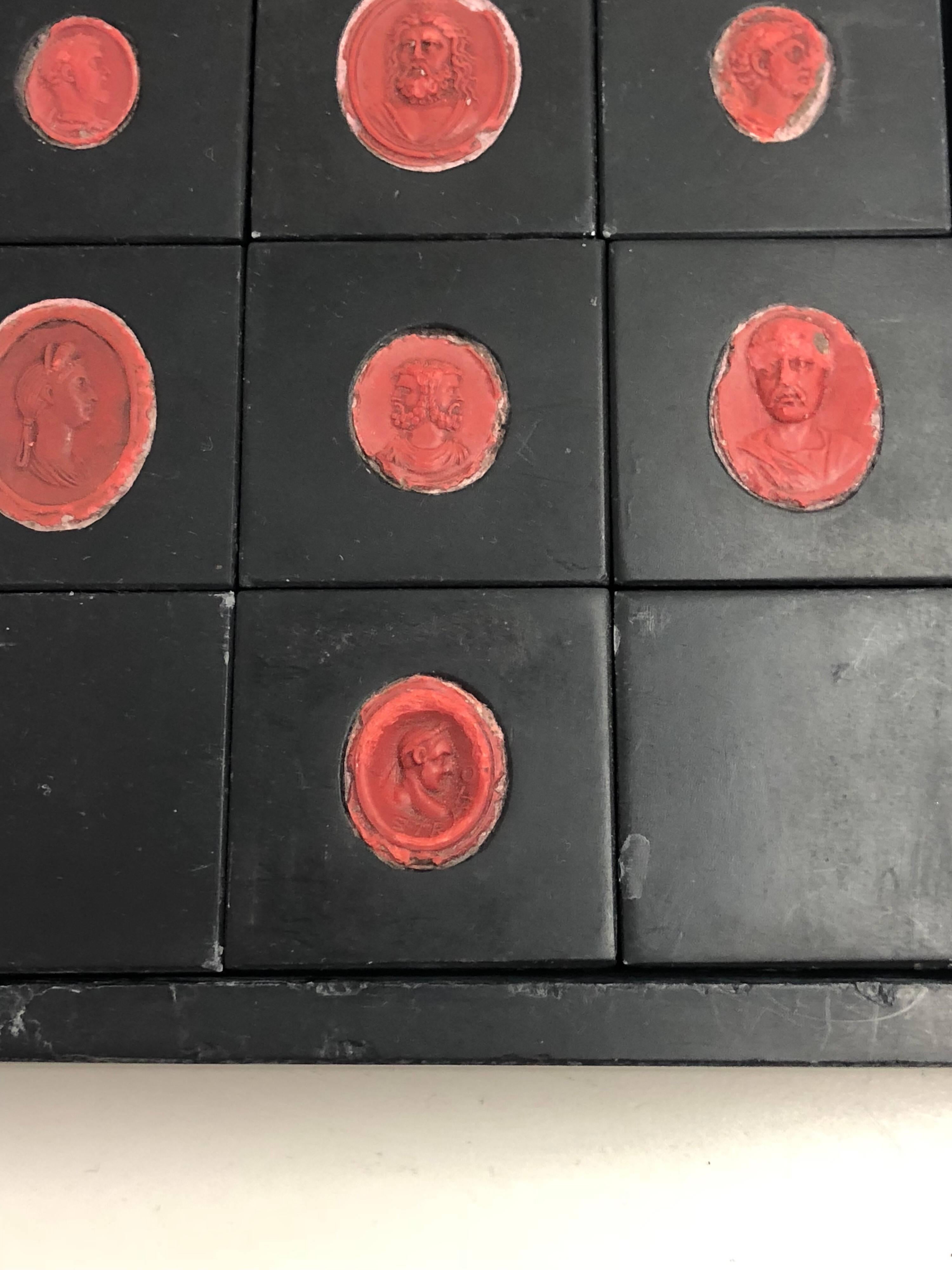 Red seals inset in black slate.