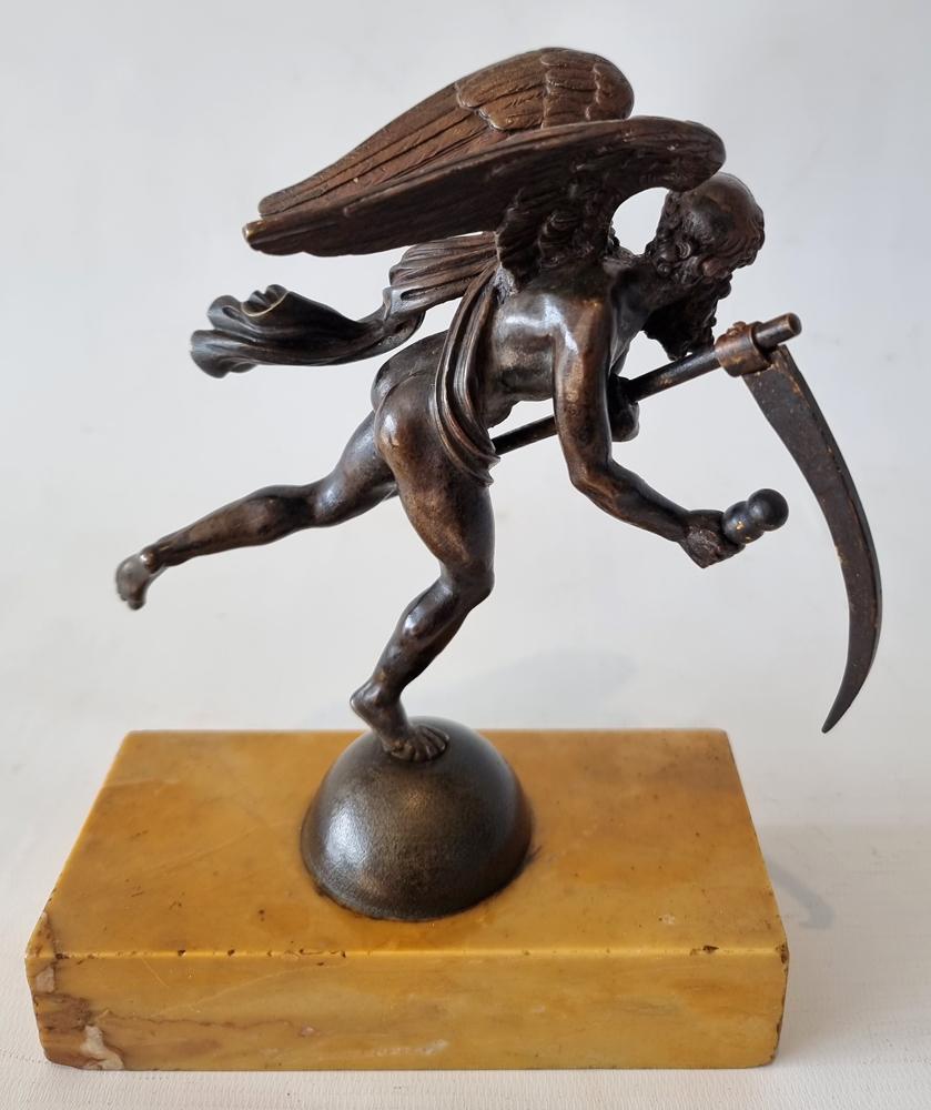 A fine patinated bronze figure of Chronos set upon a sienna marble base. A finely cast bronze figure of Chronos, the Greek personification of time. The detailed winged figure of Chronos holding a scythe and an hour glass.