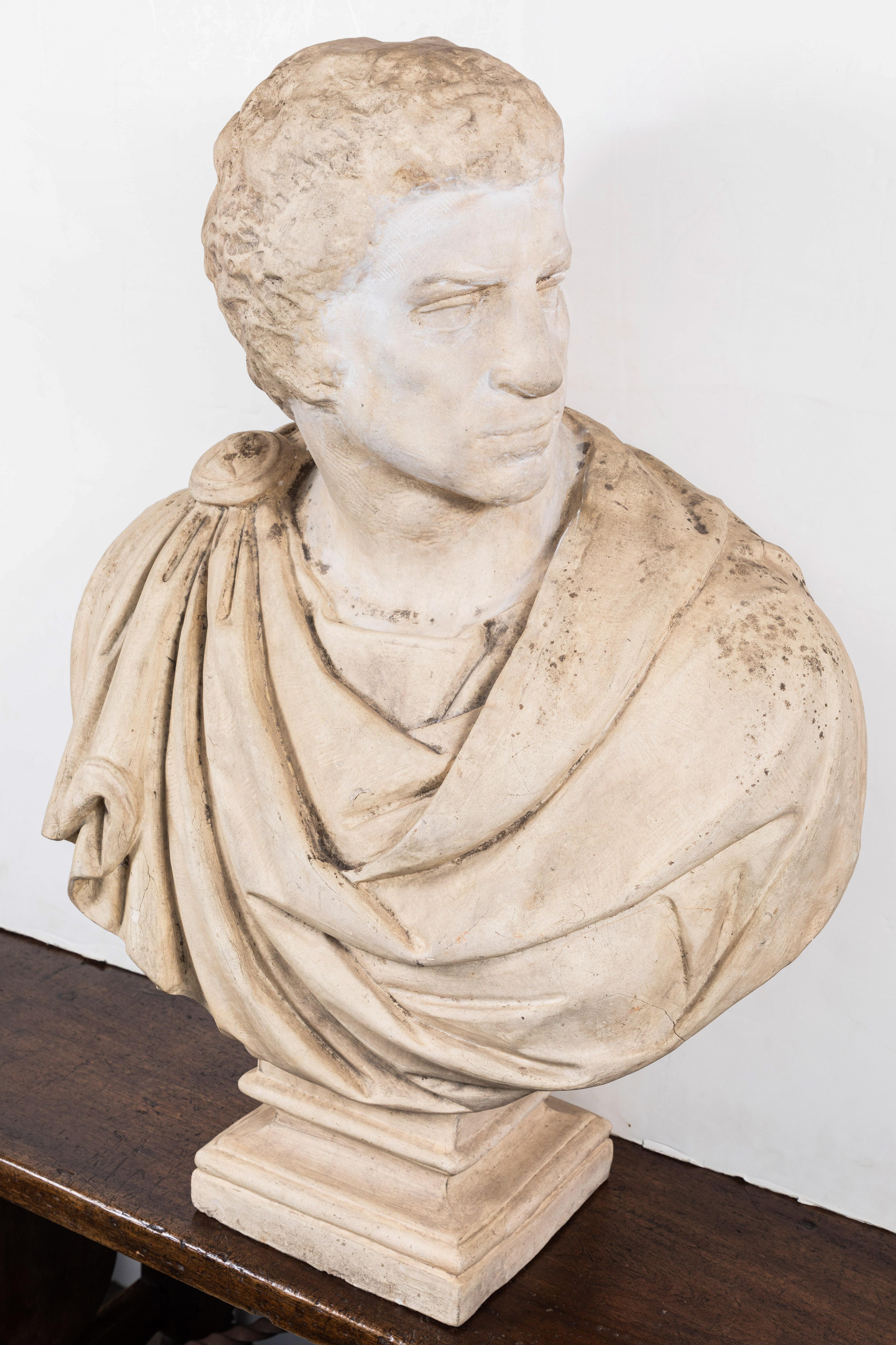 Substantial, circa 1920, Italian, plaster bust of Brutus in robes held by a clasp. Fashioned after the circa 1539, Michelangelo original.