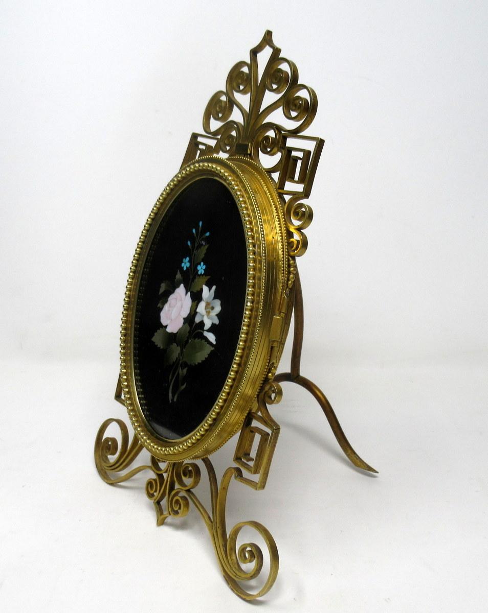 A superb Grand Tour Ormolu bronze and Pietra Dura highly decorative framed oval form plaque, of exceptional quality and Italian origin, opening to reveal a similar form photo frame, complete with original very ornate Ormolu Bronze framed easel with