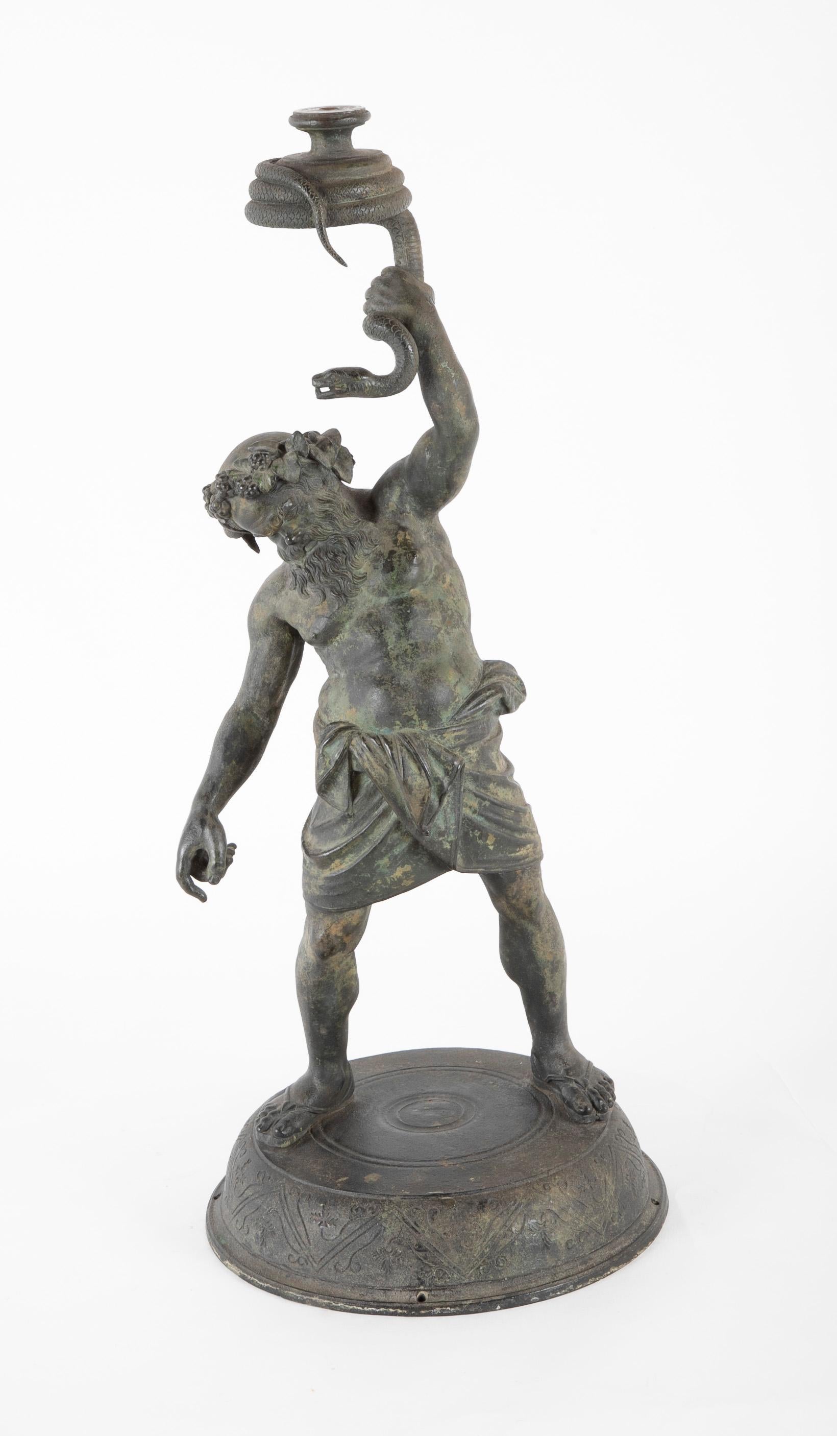 Superior quality large scale Italian Grand Tour bronze of the god Silenus after the Roman original excavated at Pompeii in 1864. This very fine cast shows the god holding aloft a coiled snake. It is believed the original sculpture held a glass orb