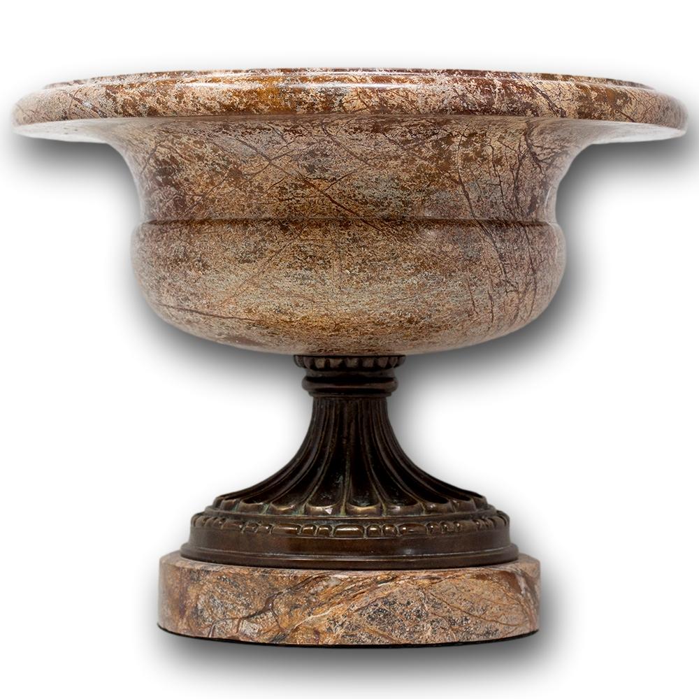 French late 19th century grand tour style Sarrancolin marble tazza urn. The vase with coloured veins of reds, pinks and whites having a large flared opening with rolled top rim mounted upon a patinated bronze pedestal with beautifully sculpted work