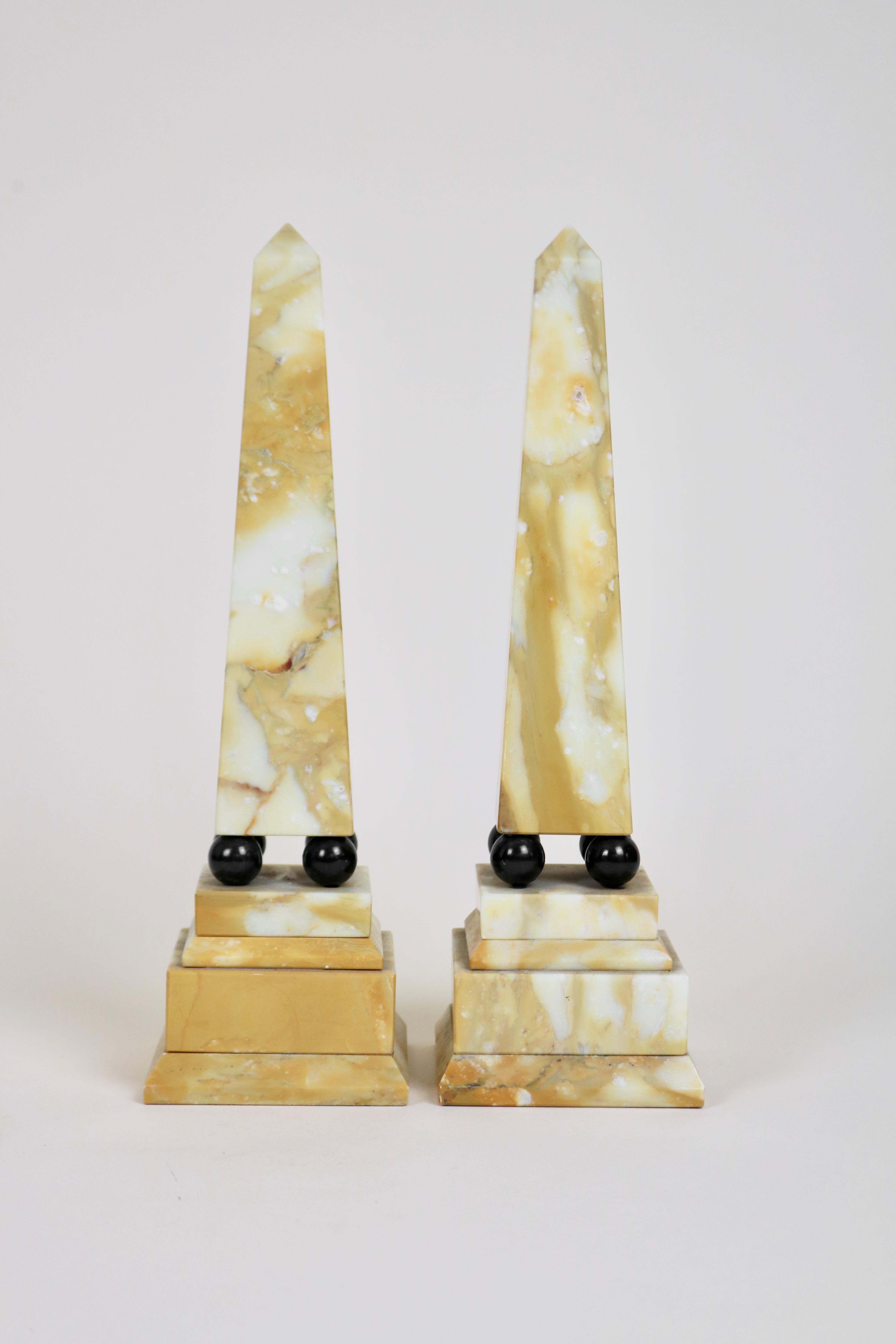 A pair of obelisks made from Siena marble with black marble ball detail. In the style of those collected on The Grand Tour.

Made in Italy in the first part of the 20th Century.

A couple of minor chips.
