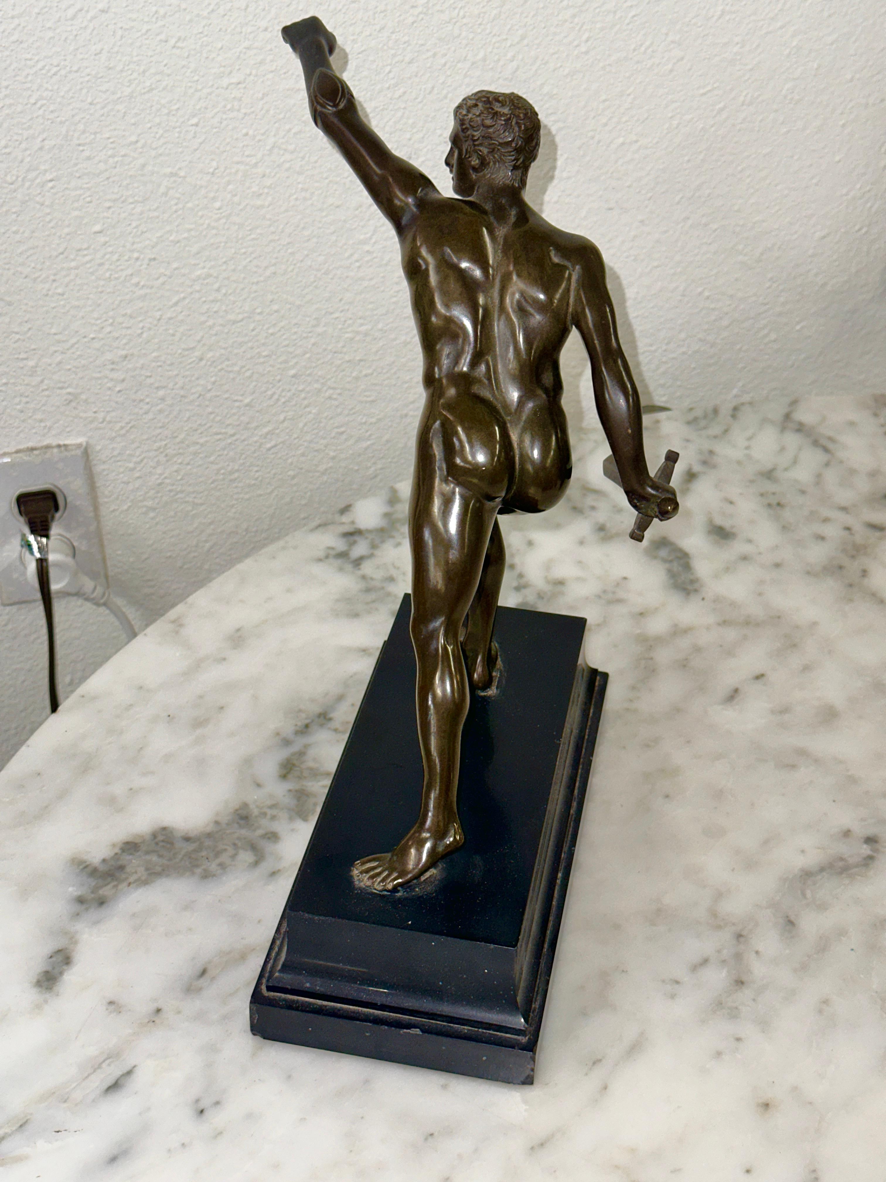 A nice done late 19th Century Bronze after the Borghese Gladiator. This grand tour souvenir is mounted on black marble or slate and is nicely patinated. It stand approximately 12.5 inches tall. The bronze itself is in good condition with some patina
