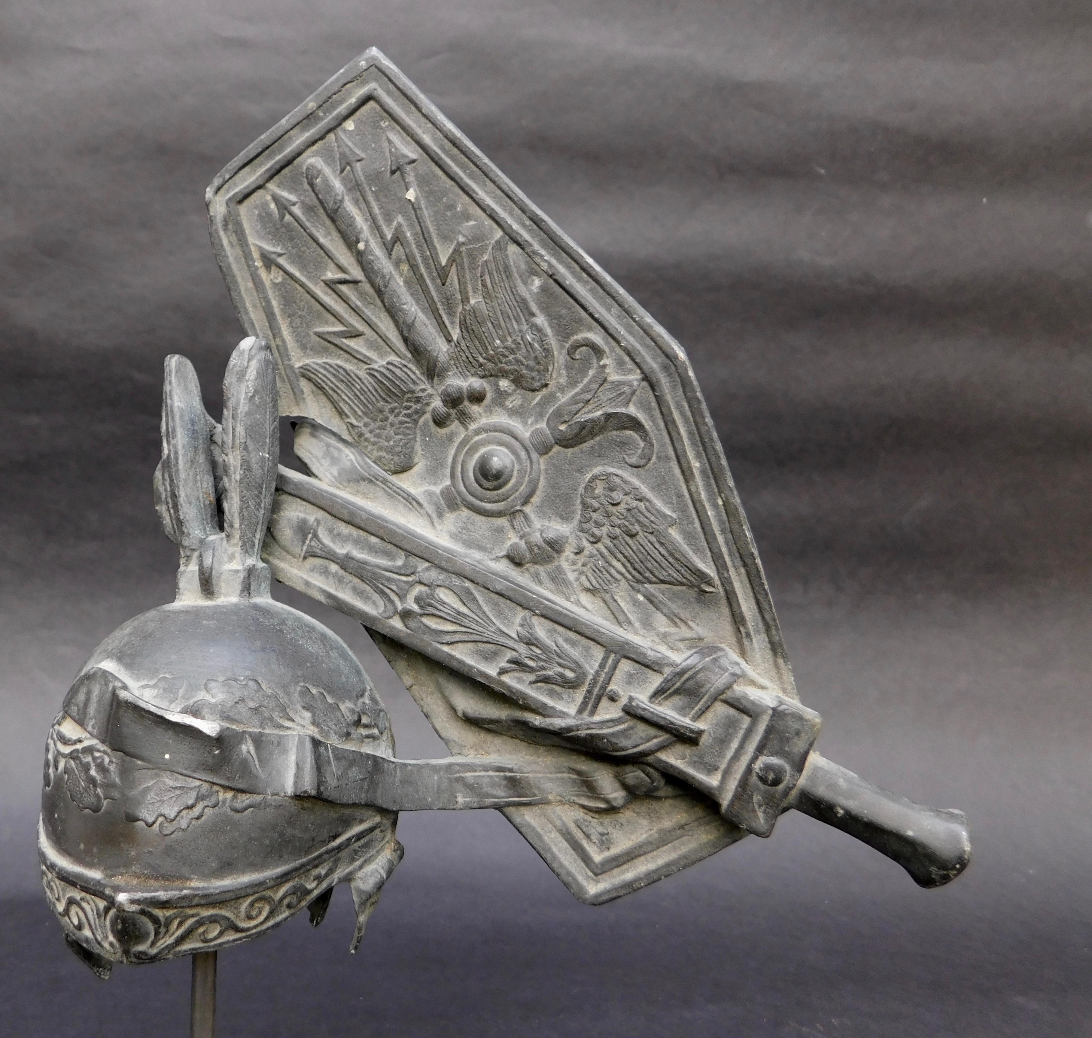 Grand Tour souvenir cast metal fragment on stand of a Roman Centurions helmet and shield, circa 1890.