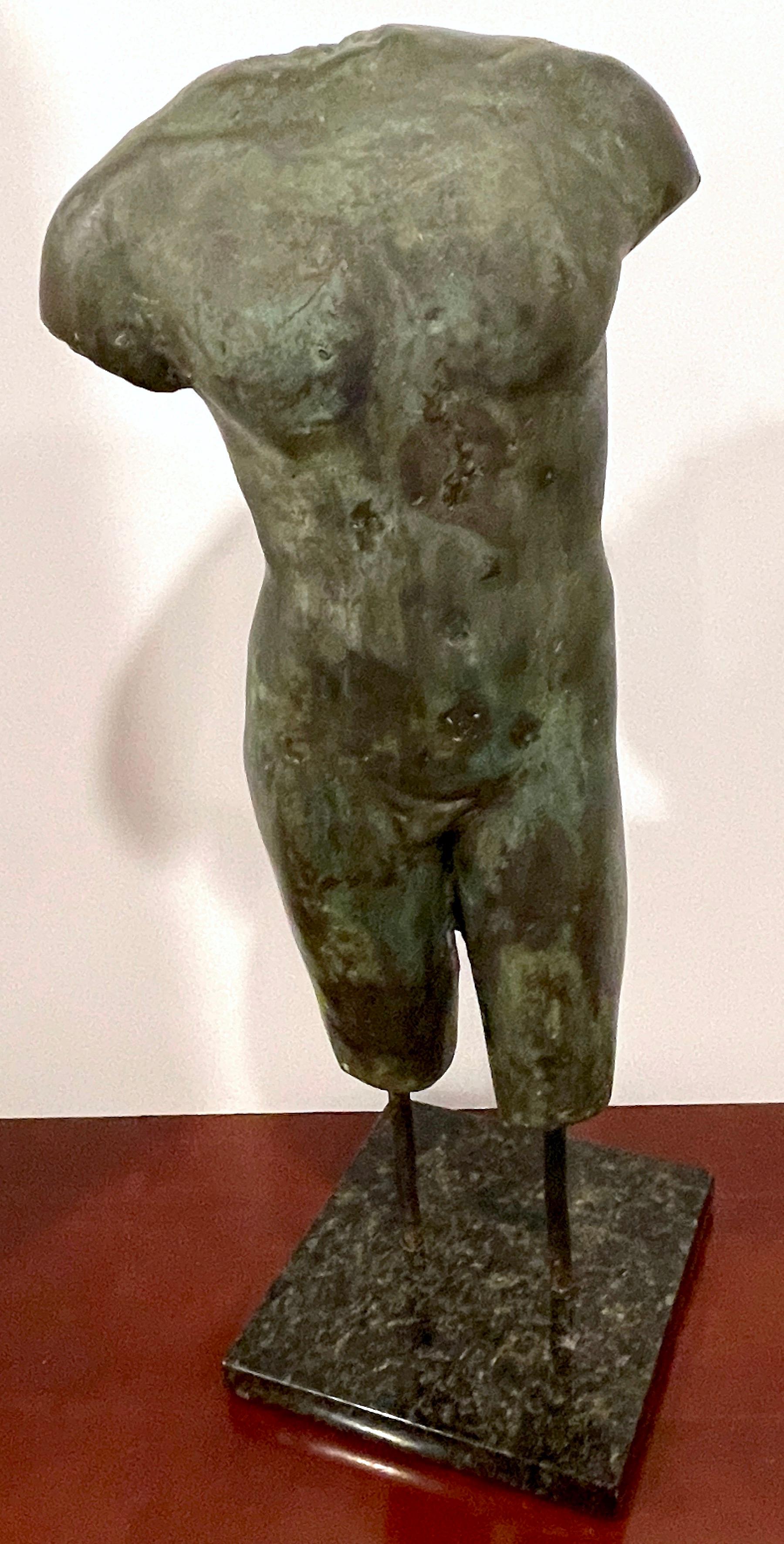 Grand Tour Style Greco-Roman Bronze Male Nude Torso Fragment, Museum Mounted 
20th Century Casting, Purchased in Europe, 1970s

Representing the allure of the Grand Tour era with this captivating Greco-Roman bronze male nude torso fragment,  a work
