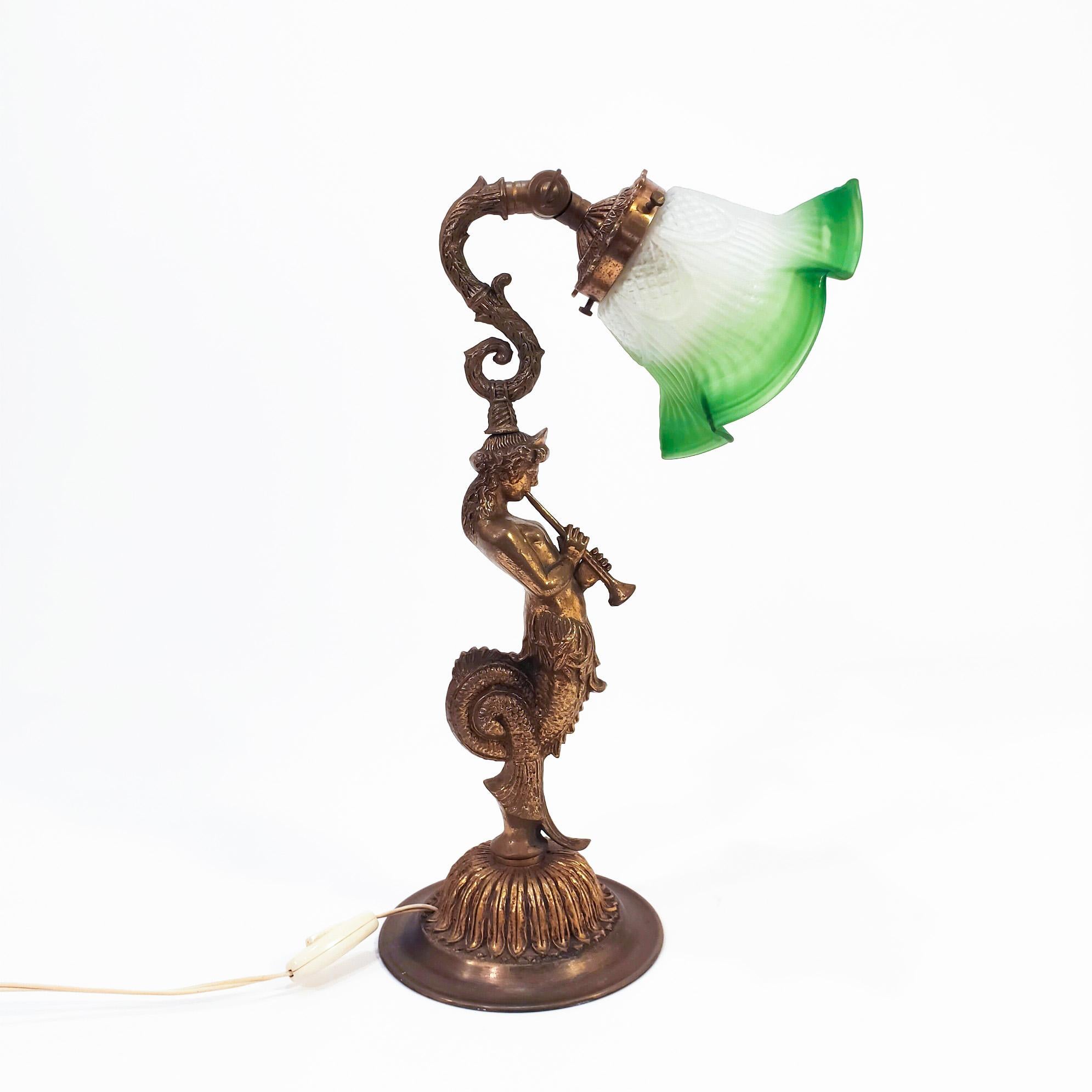 Grand tour table lamp in French empire style circa 1920, France. This piece depicts the King Cecrops from Greek mythology in his youth and playing an aulos (wind instrument from ancient Greece). With half a snake body, this king was the first of the