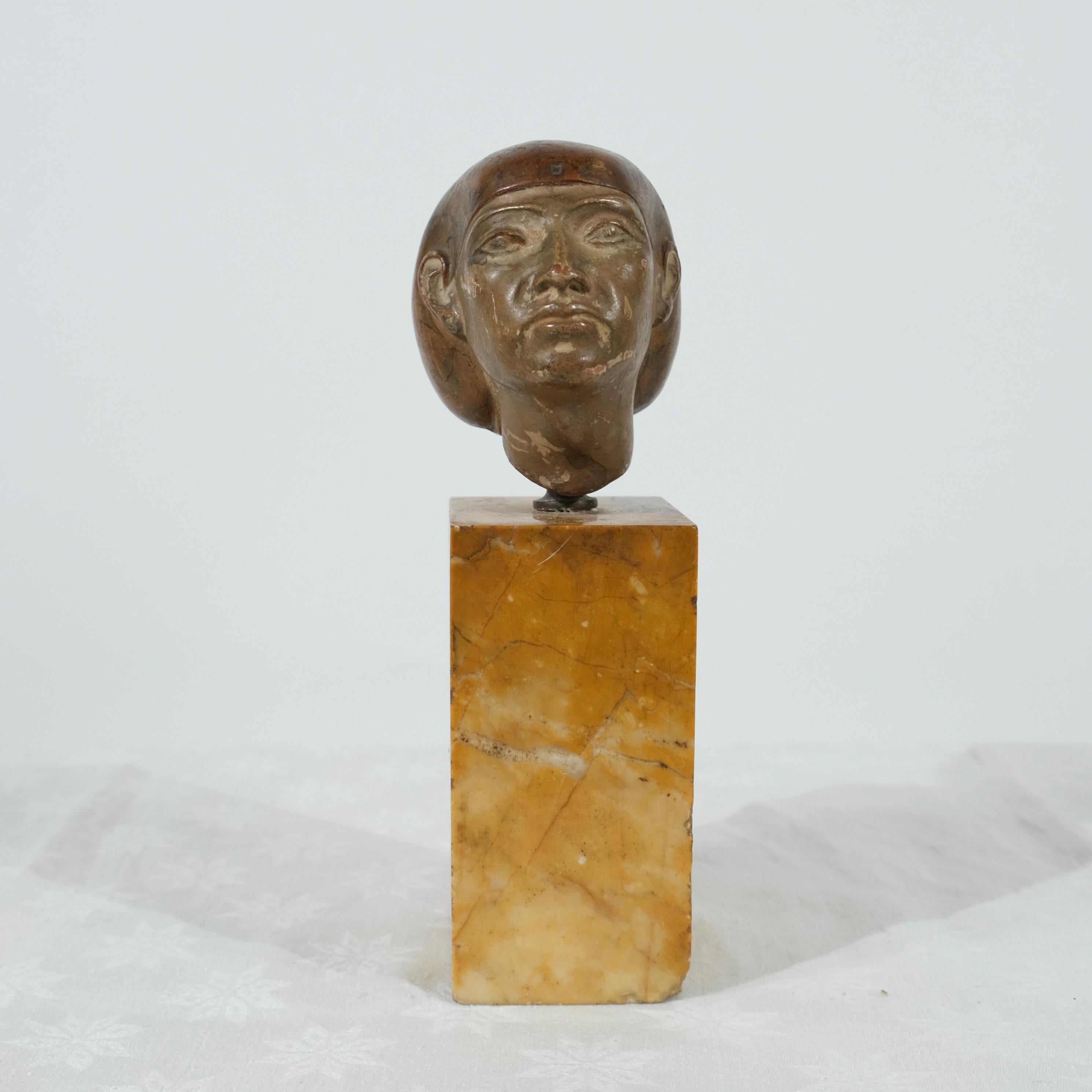This striking small bust captures the timeless elegance of an Egyptian princess, inspired by the art and aesthetics of Tell-el-Amarna, a period known for its distinctive representations of royalty and grace. Carved in terracotta and painted, the