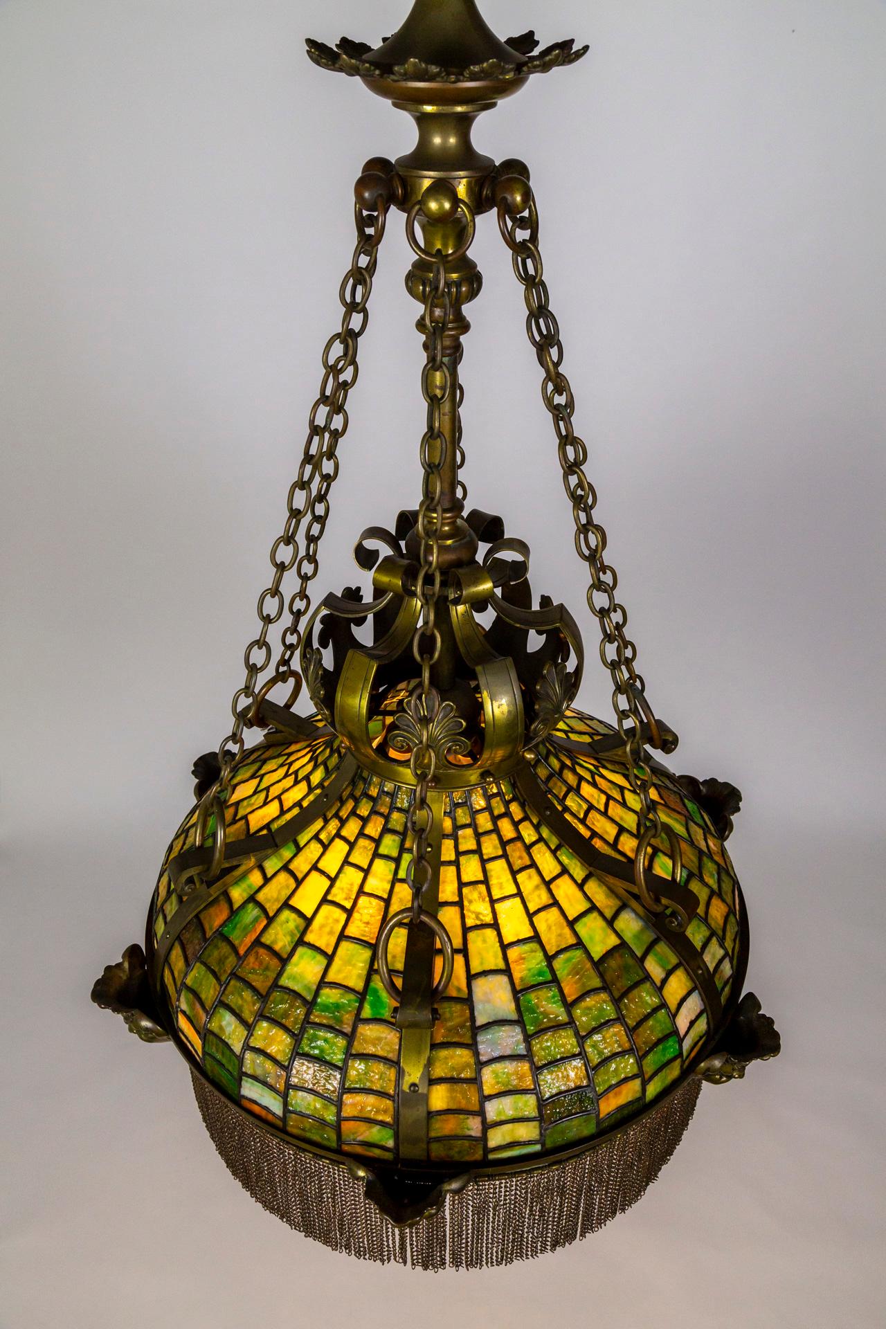 An expertly crafted, late 19th century, mosaic-style slag glass pendant light in a crowned, umbrella shape with subtle undulations; excellent lead work- the glass itself is textured and complex, in graduated sizes with unexpected variations in
