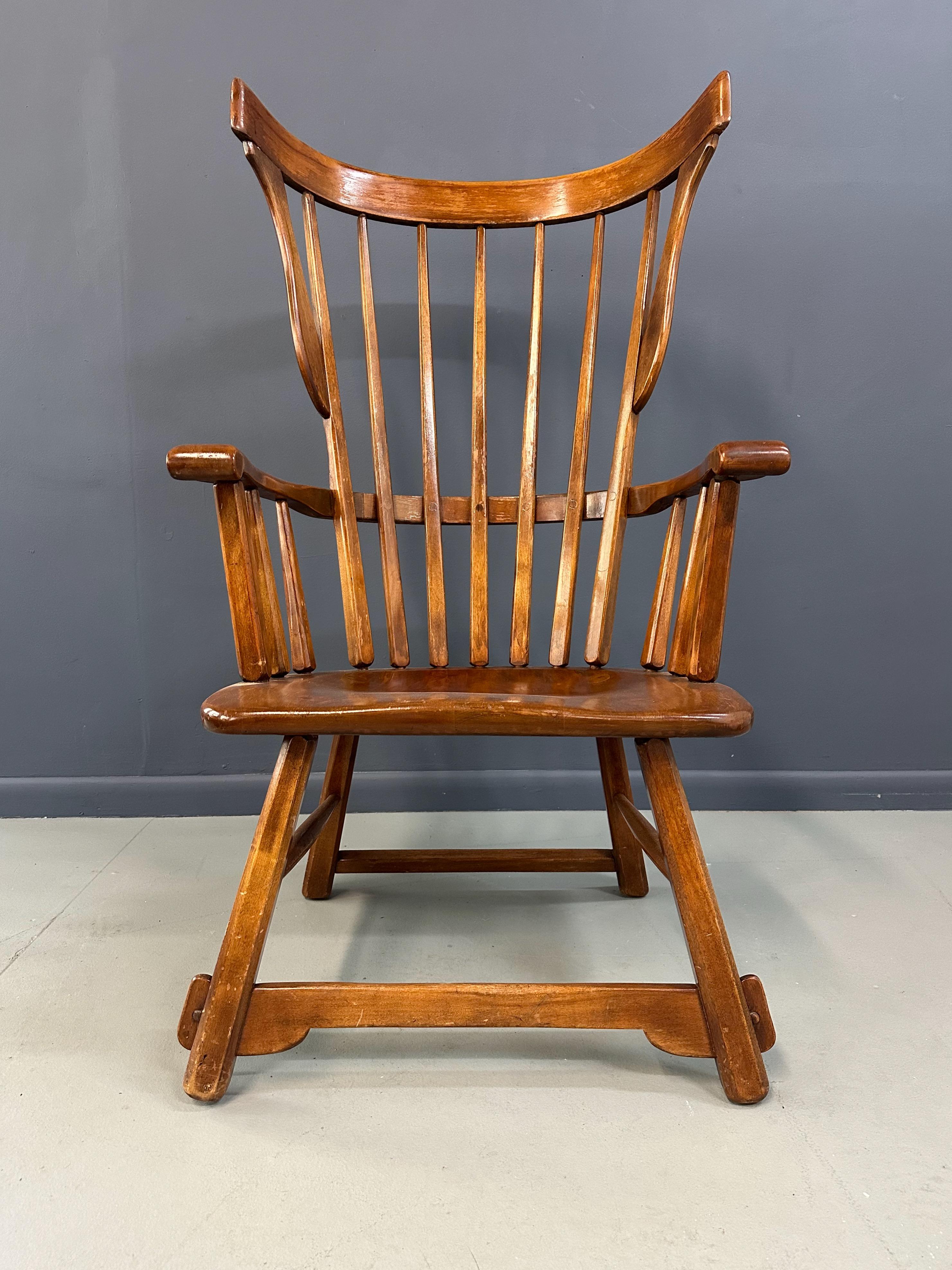 The Grand Windsor Chair by The Sikes Company of Buffalo  designed by Herman de Vries is a timeless piece of furniture that combines elegance and durability. Crafted with expert precision, this chair boasts a sturdy frame and intricate details that