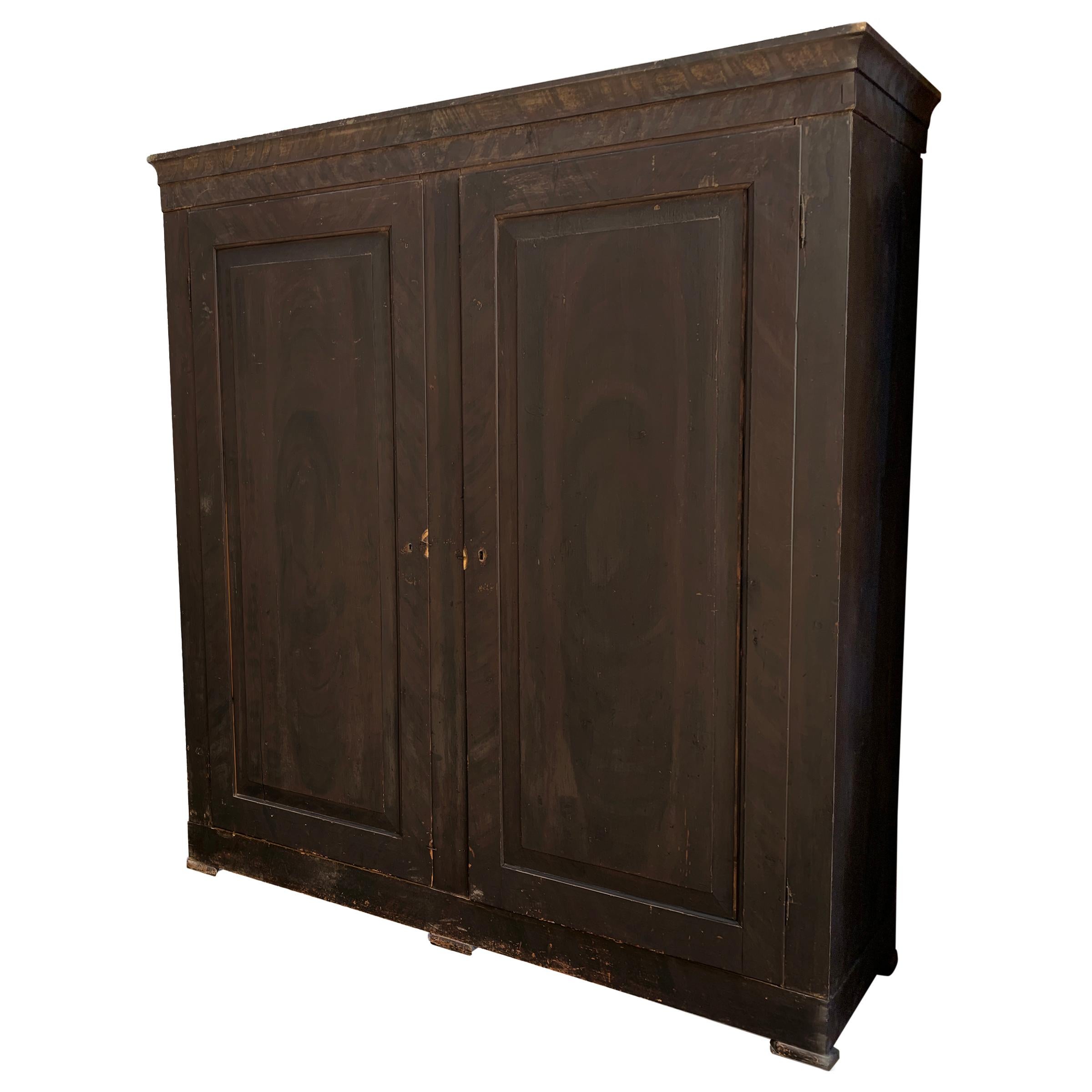 An outstanding grande-scale 18th century Italian pine two-door cabinet with a folky faux wood grain painted finish and one shelf on the interior. Cabinet comes completely apart so it's perfect for city apartment installations.
