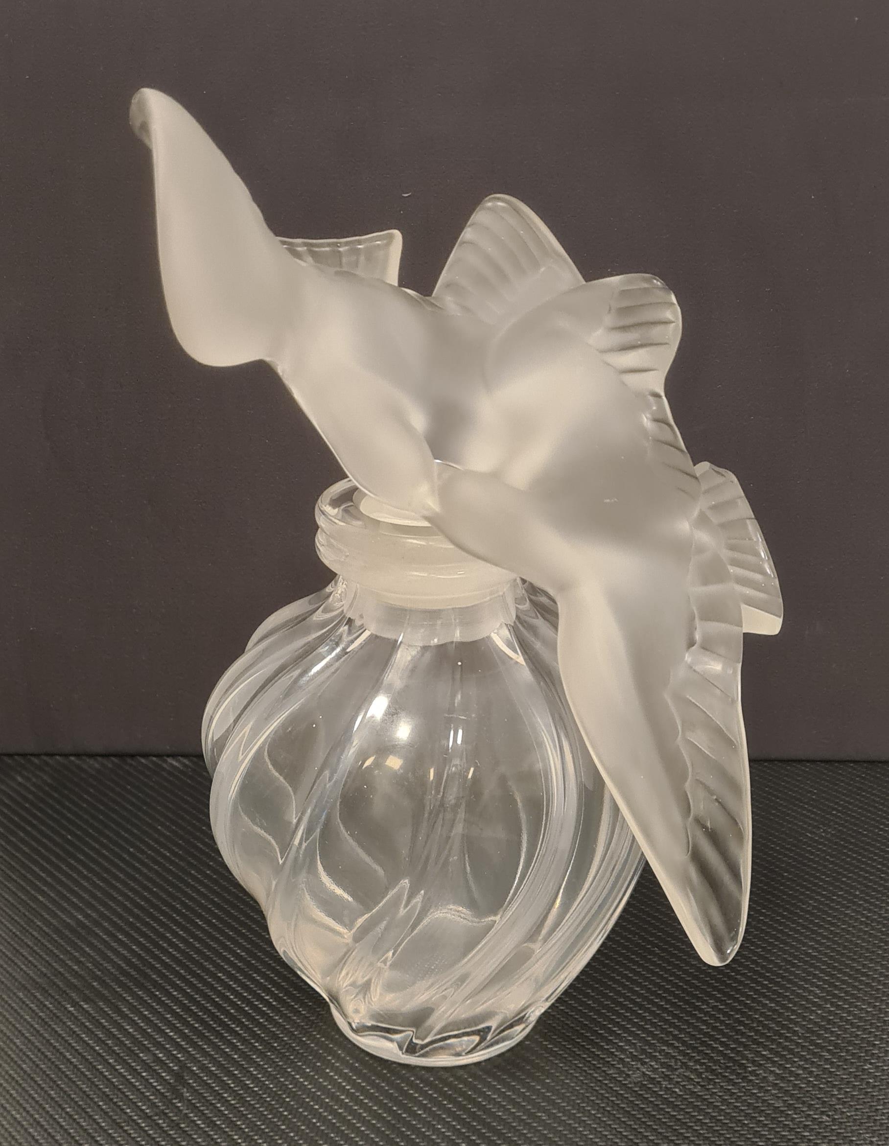 Large collectible bottle made by French glassmaker Lalique.

Bottle that contained the perfume 