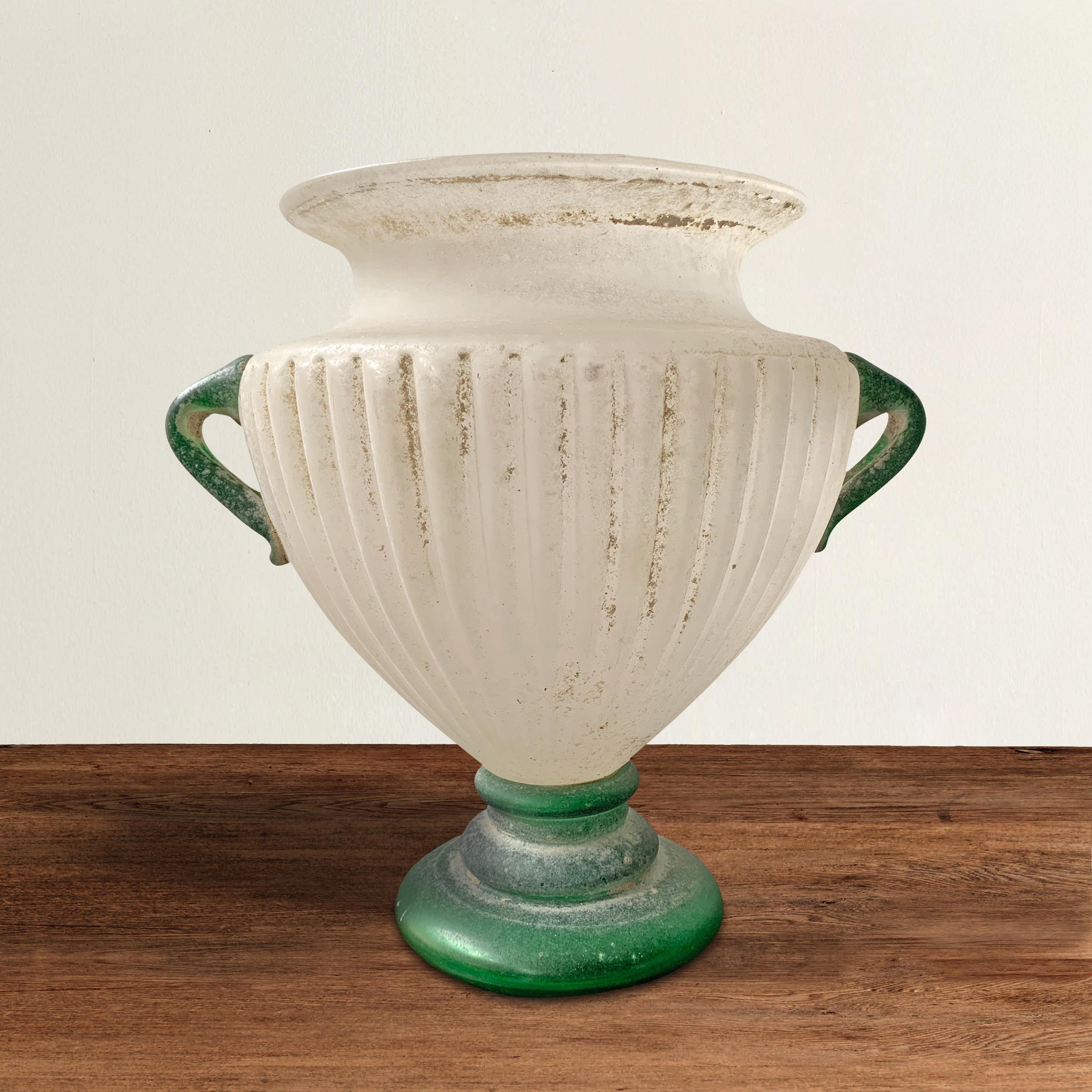 A Grande mid-20th century Italian Murano blown scavo glass vase of Classical Roman form with two green glass handles applied to an opaque white fluted vase resting a tiered green glass foot. Scavo is Italian for 