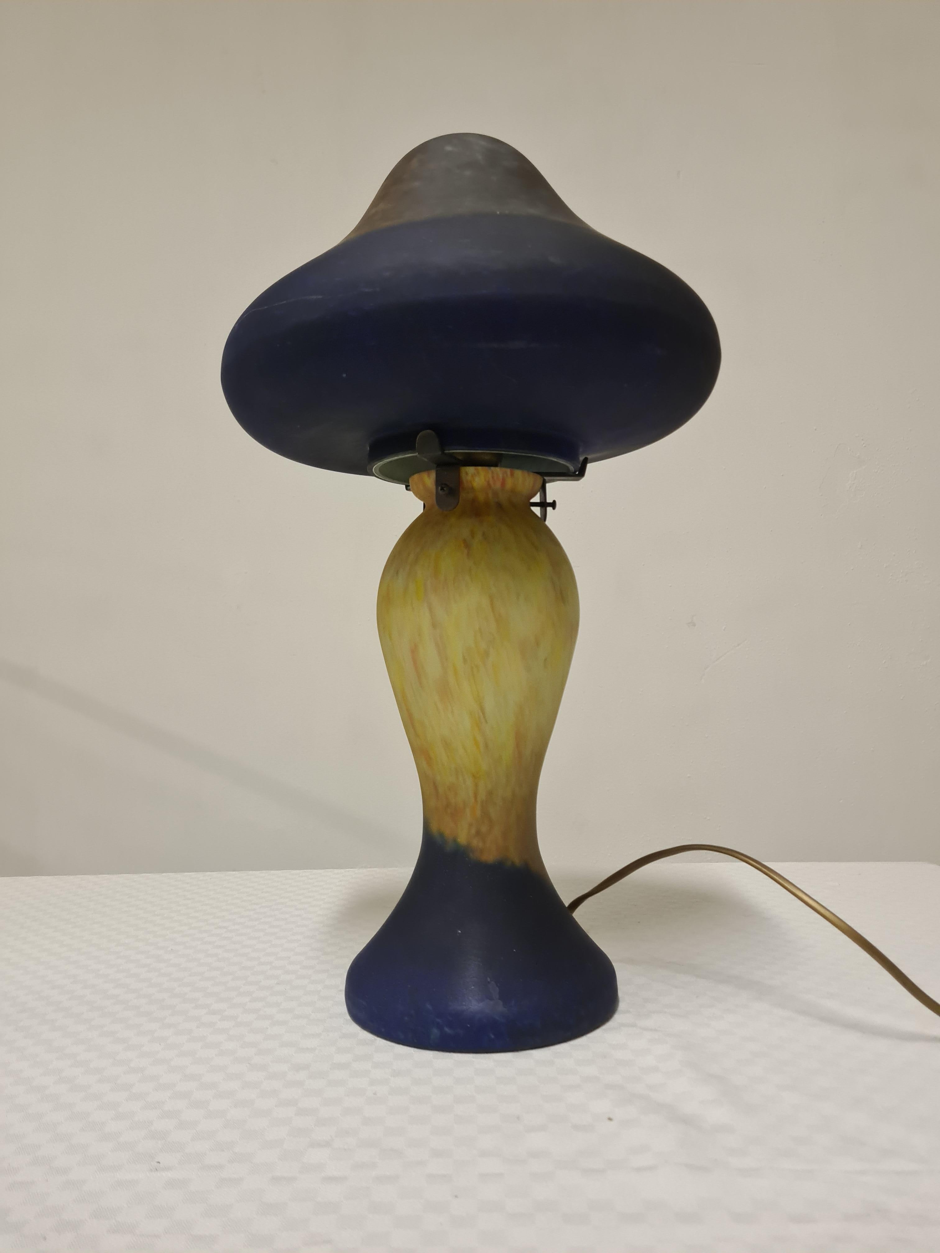 Large lamp in Art Nouveau style.

Mushroom-shaped table lamp made of acid-frosted glass paste.

Refined and gentle, with the typical form and style of art Nouveau.

Colors ranging from blue to yellow.

The structure made entirely of glass means that