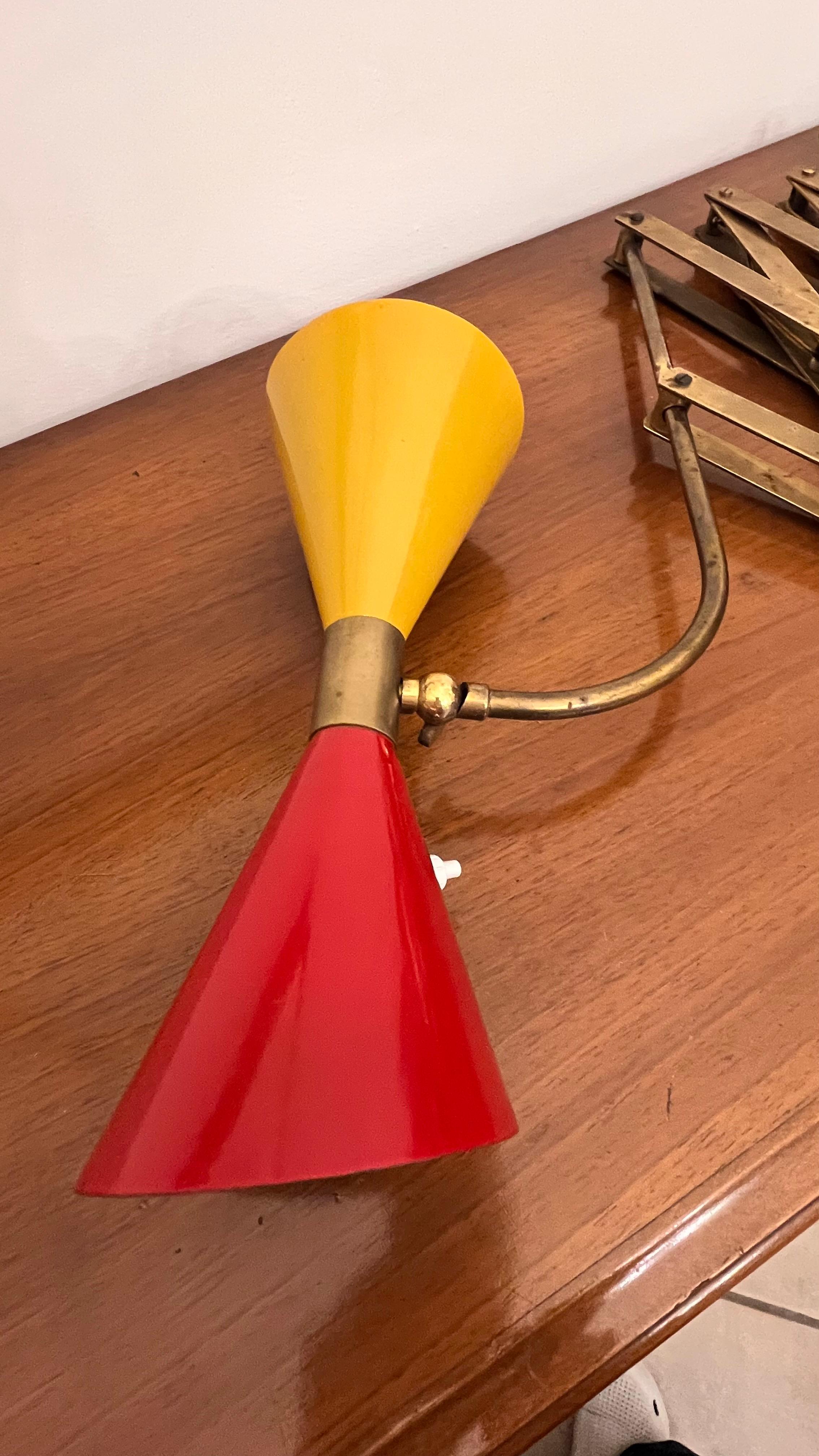 Large extendable wall lamp, stylish and contemporary  in the Stilnovo style with two-tone lampshade. The accordion part is made of brass , the double cone shade of enameled aluminum , with double ignition .
The lamp has some imperfections due to
