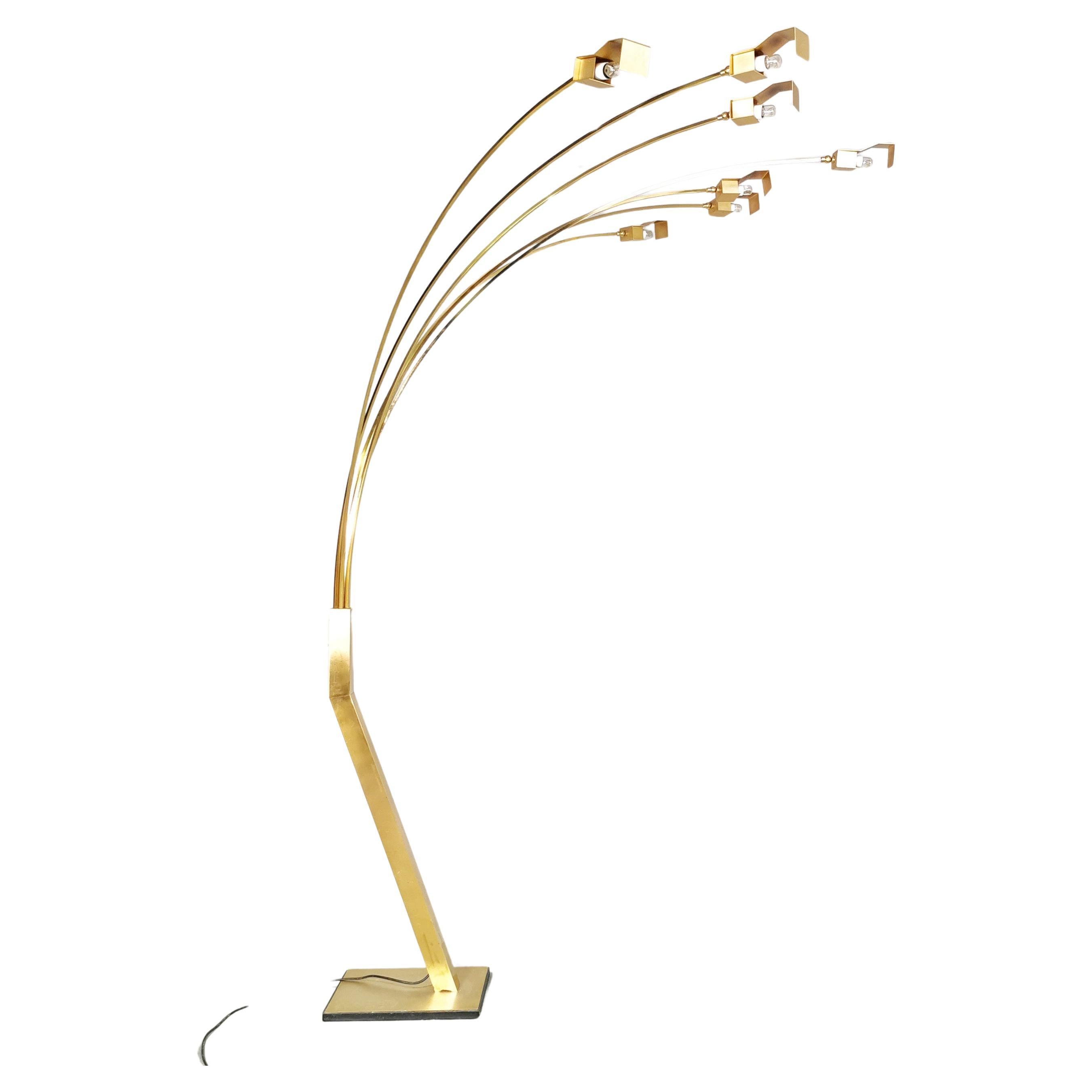 Large floor lamp n brass with sculptural base with as many as 7 arched stems and golden metal diffusers. 
We found no attribution for a designer or manufacturer of this rare, high-impact lamp version in a living room or showroom
condition is very