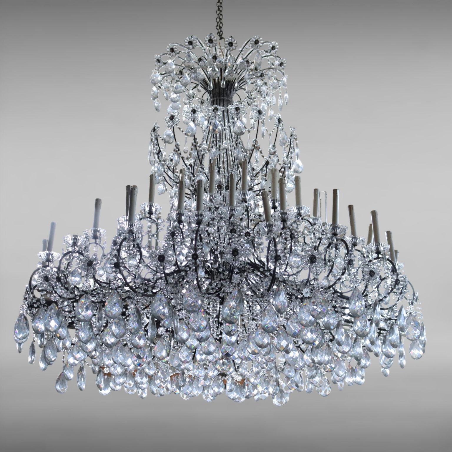 Large chandelier with metal frame, richly ornamented with crystal pendants and necklaces; features three stages each of 18 lights, with glass bobeche.
Lamp that due to age and wear may require restoration work, and probably has an electrification