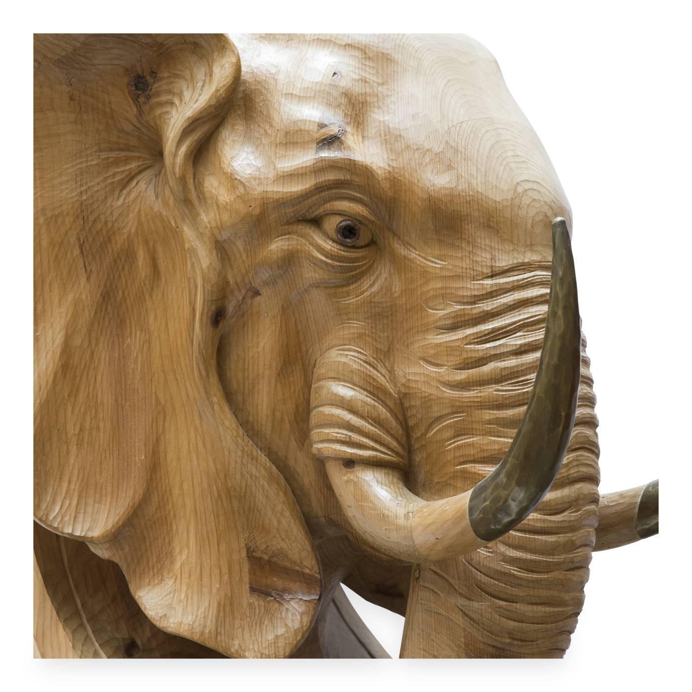 This magnificent elephant sculpture by Bartolozzi e Maioli serves as a stylish console table base. Designed in 1975 for a private South African residence, the piece is entirely hand-carved out of a block of Austrian pine, with impressive tusks