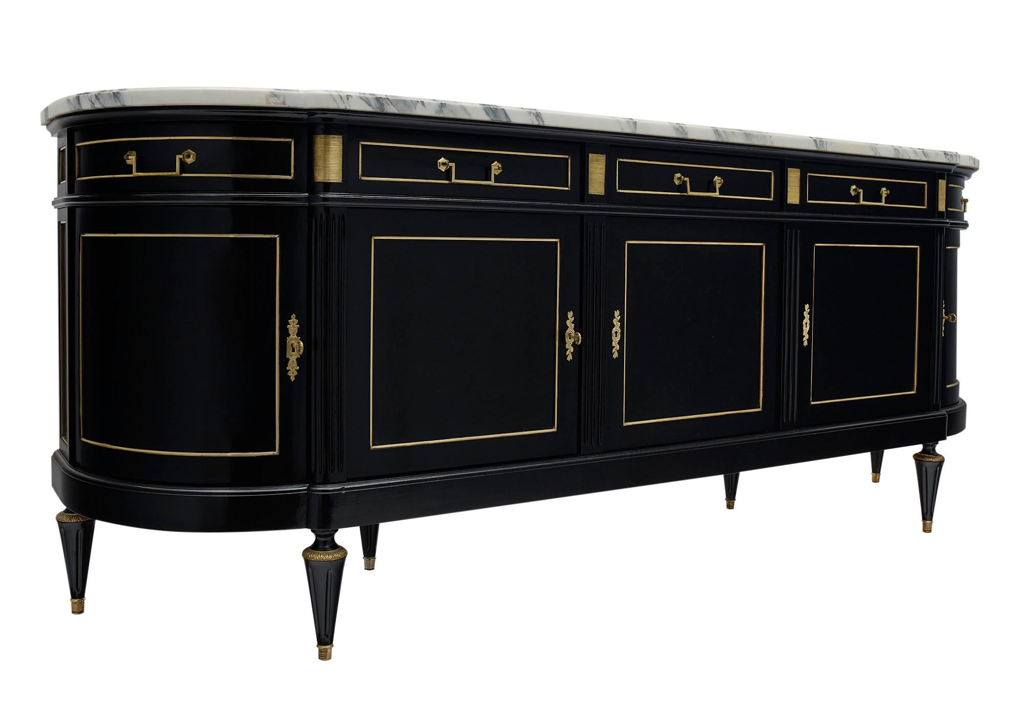 Buffet or enfilade made of mahogany from France in the Louis XVI style. There are five dovetailed drawers above five doors opening to adjustable shelving. This stately sideboard features a lustrous Museum-quality French polish, gilt brass trims and