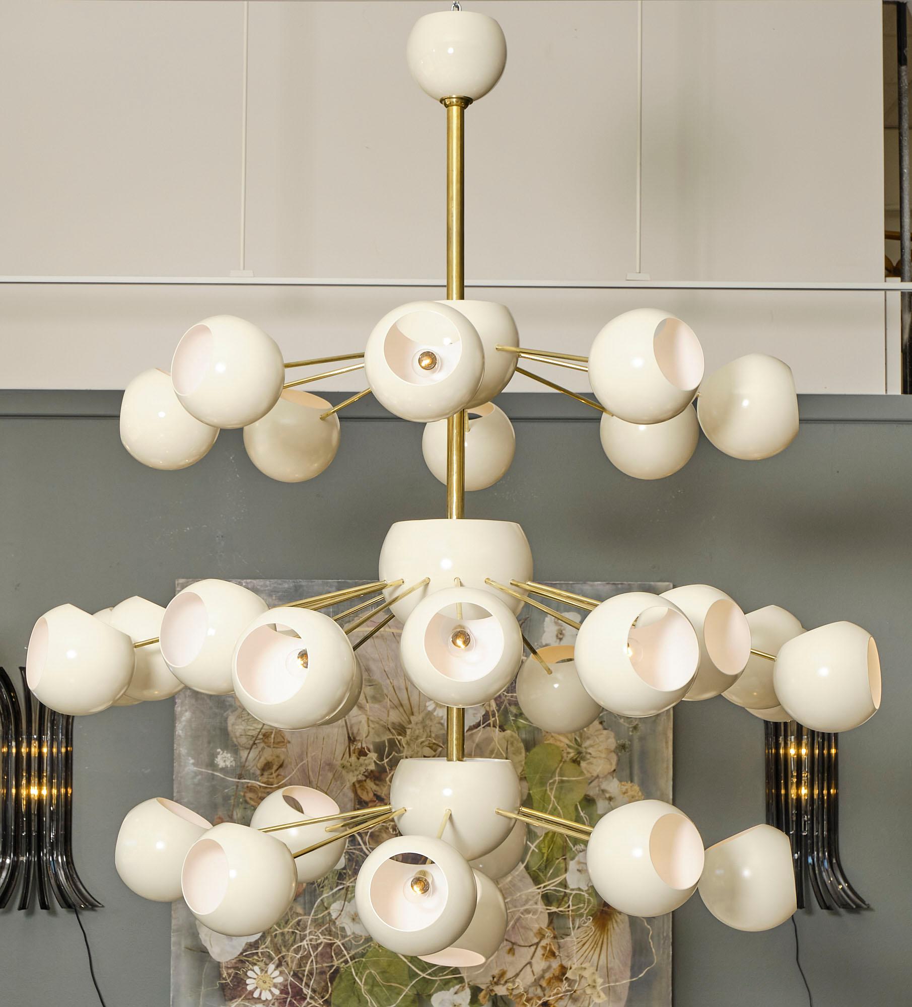 Chandelier, Italian, from the Veneto region with multiple ivory steel lacquered orbs connected with brass stems to the main body of the piece. This chandelier has been newly wired to fit US standards.