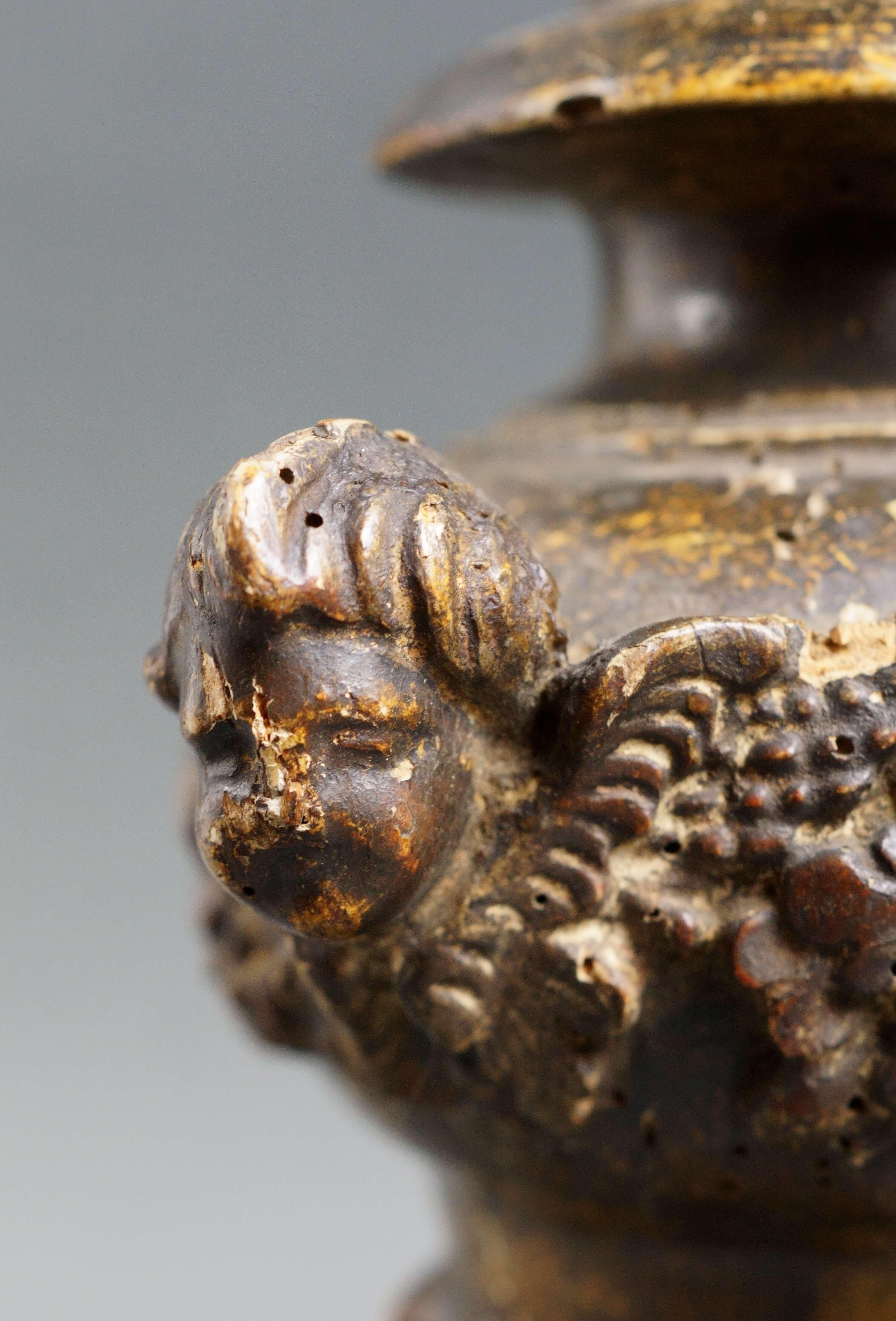 Grande porta cero da altare barocco in legno riccamente scolpito con tre teste di cherubino, tralci floreali e festoni a tutto tondo. Italia, inizi XVIII secolo. Laccatura originale. Chiodo e raccoglicera originali . Ottimo stato di conservazione,