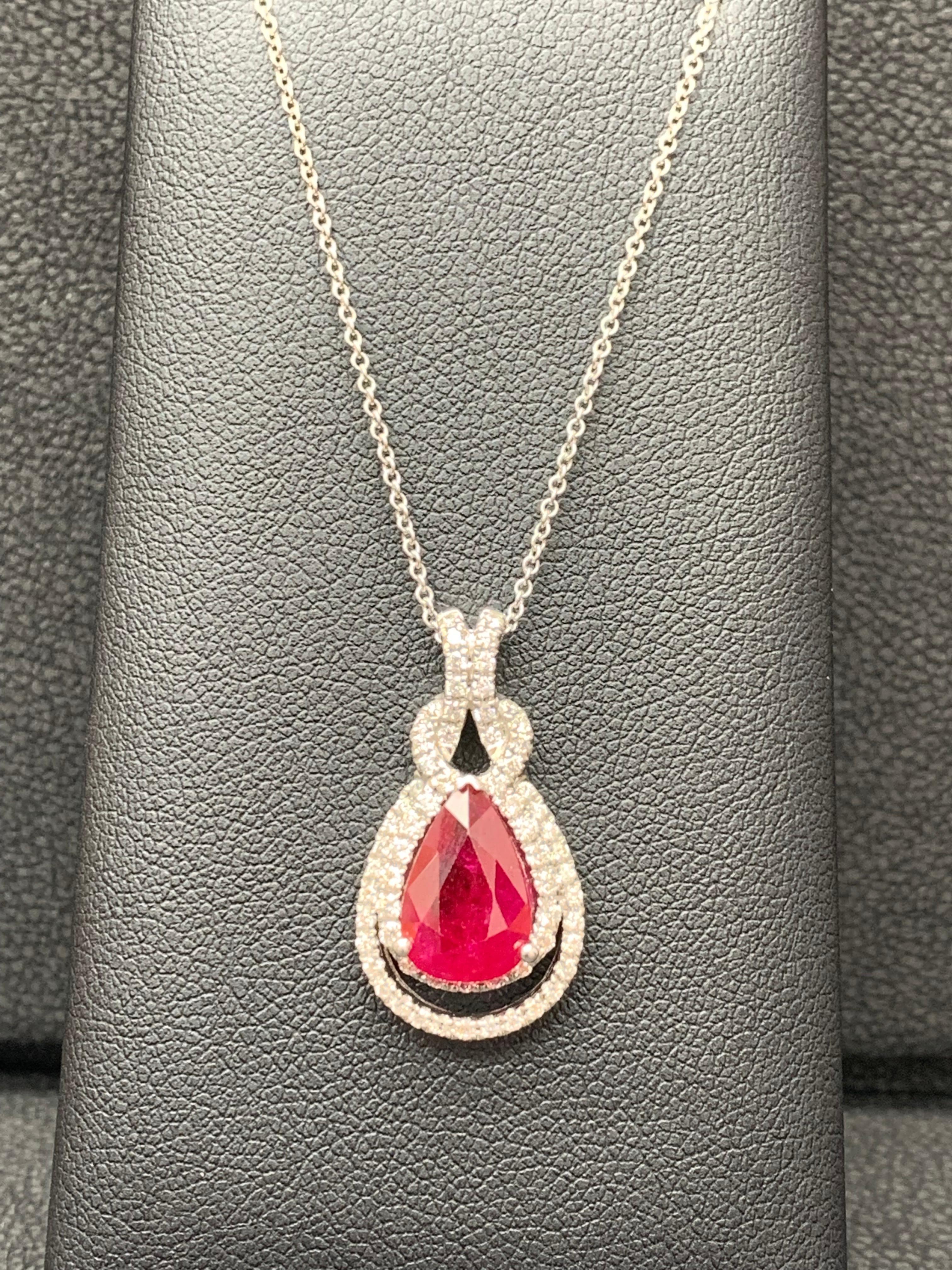 Showcasing a pear shape 0.51 Carat Ruby surrounded by two-rows of round brilliant diamonds in a open-work design. 31 round Diamonds weigh 0.26 carats total. 18